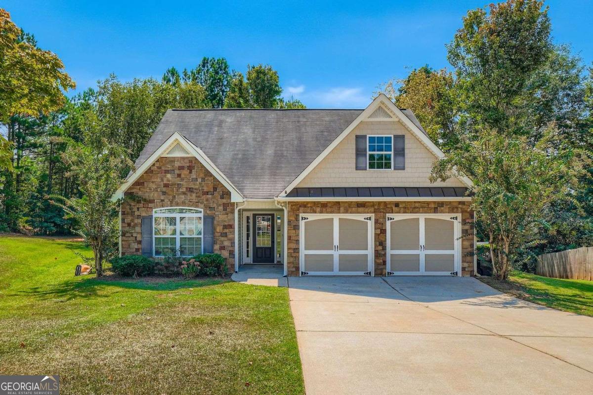 Ideally located just minutes from I-20 and Carrollton Villa Rica Highway, this beautifully maintained 3-bedroom, 2-bathroom home combines style, comfort, and convenience-with no HOA restrictions. The spacious living room features soaring vaulted ceilings and a stone-faced fireplace, creating a cozy and welcoming atmosphere. A formal dining room with elegant double tray ceilings adds a refined space for entertaining, while the kitchen offers a charming breakfast nook, Grand Pearl countertops, and a dishwasher, perfect for everyday living. The primary suite serves as a peaceful retreat, complete with double tray ceilings, a walk-in closet, dual vanities, a soaking tub, and a separate glass-enclosed shower. Outdoor living is easy with a rear patio and fenced backyard, offering privacy and space for pets, play, or relaxation. Additional features include a 1.5-year-old HVAC system-providing comfort and peace of mind. This home blends thoughtful design with a prime location close to shopping, dining, schools, and commuter routes-making it a standout in the Villa Rica area. Discounted rate options and no lender fee future refinancing may be available for qualified buyers of this home. Priced to sell and move-in ready.