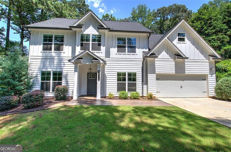 Welcome to 4640 Bells Ferry Road, a home that feels just right from the moment you walk in. Located minutes from Woodstock, Kennesaw, and I-75, this two-story beauty combines style, comfort, and a super convenient location with no HOA. Step inside to a bright, open layout with laminate floors and plenty of space to gather or unwind. The kitchen flows easily into the main living area, where custom upgrades like a dry bar, accent cabinet wall, and updated lighting bring a touch of character and warmth. Upstairs offers four comfortable bedrooms and two full baths, including a spacious primary suite with a walk-in closet. A half bath downstairs makes it easy when guests are over. Out back, enjoy a covered patio, tiled walkways, and fenced front and back yards that give you room to relax, play, or entertain. Smart home touches like a front and rear camera system, smart lock, gutter guards, and trim lighting add both function and curb appeal. If you're looking for a well-kept home with thoughtful upgrades in a location that puts everything within reach, this one's worth seeing in person.