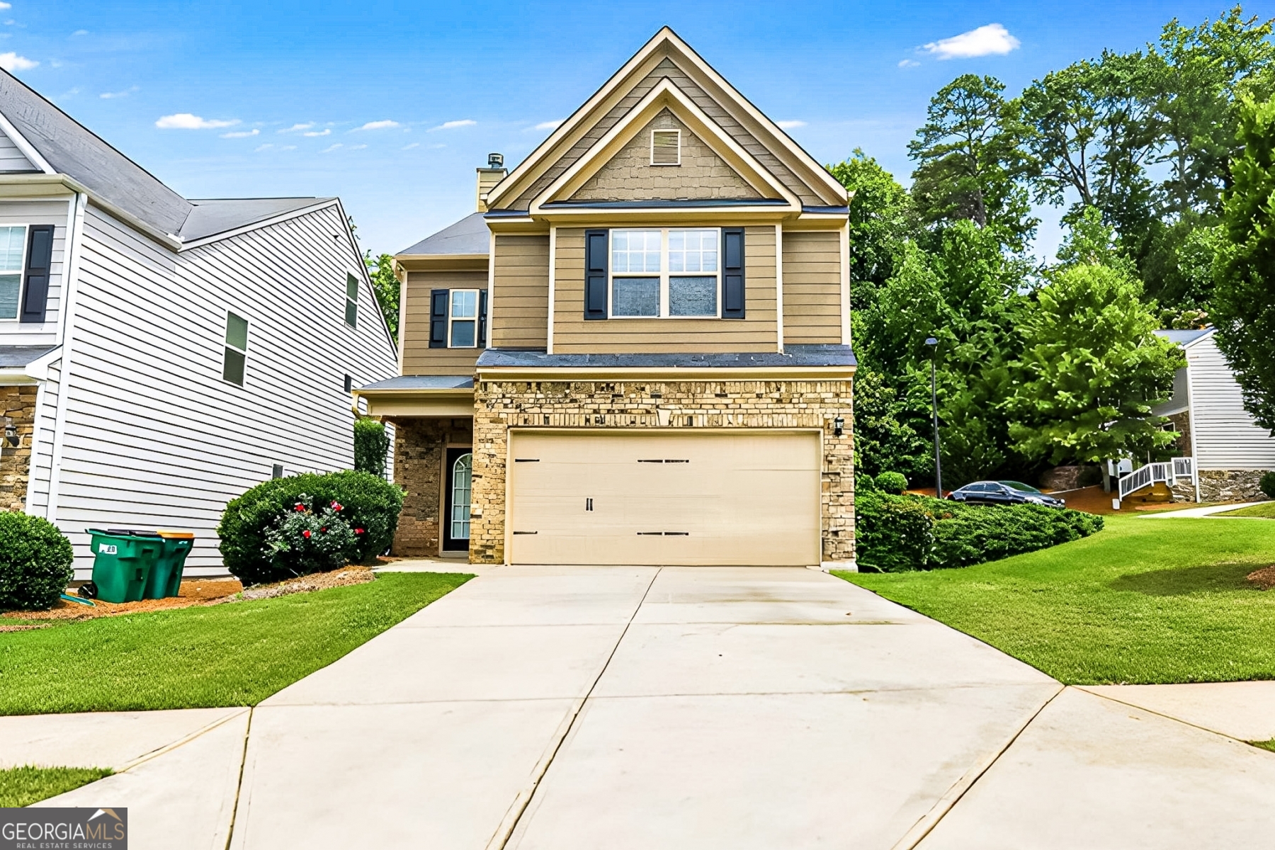 Discover serene living at 315 Lakeside Lane - a thoughtfully designed Craftsman retreat on a rare 1-acre level lot in the heart of Woodstock Village. Built in 2014, this 4 bed, 3.5 bath home offers 2,530 sq ft of modern comfort paired with timeless charm. Step inside to a bright, open layout featuring hardwood floors, soaring ceilings, and a cozy gas fireplace in the great room. The chef's kitchen is outfitted with stainless steel appliances, shaker cabinetry, and generous counter space - perfect for gatherings and everyday meals. Upstairs, the spacious primary suite features a tray ceiling, walk-in closet, and spa-style bath with soaking tub, double vanities, and tiled shower. Three additional bedrooms provide options for guests, home office, or flex space. Enjoy privacy with no rear neighbors and a wooded backdrop, all within a quiet, sidewalk-lined community with low HOA fees and a community pool. Zoned for top-rated schools and just minutes to Downtown Woodstock and I-575.