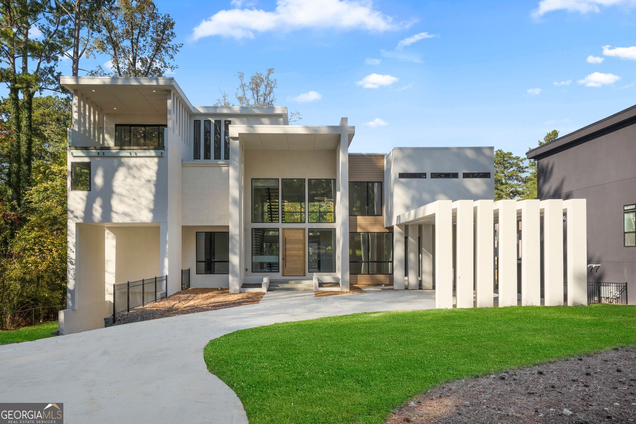 Welcome to this exceptional, custom-designed, new construction, modern contemporary home built by Maison Developement and nestled in the beautiful, North Decatur neighborhood. Meticulously crafted with luxury and detail, this home offers palatial views spread across four levels of unmatched design that includes elevator access to all levels. Upon entry, a stunning pivot door leads you to the grand 2-story foyer and great room, with an eye-catching floating staircase accented with frameless glass railings that offer unobstructed views of the home's modern architecture. Oversized windows throughout the home lend themselves to an abundance of natural lighting. To the right of the entryway is the spacious dining area, anchored by designer lighting that complements the home's sophistication.The Chef's kitchen features sleek onyx leather quartz countertops with an expansive waterfall island, flat-panel soft-close cabinetry, and a custom oak vent hood. The 6-burner Wolf double oven range is a well appointed gem. An extended walk-in pantry offers ample storage. The kitchen seamlessly opens to the 2-story great room, which boasts a double-sided fireplace and large sliding doors that lead to a massive balcony, making it ideal for indoor-outdoor entertaining. Adjacent to the great room is a well-appointed bar and den, a versatile space that could serve as an additional private dining area bar or lounge. Additionally, on the main level, you'll find a stylish home office and a guest suite featuring a steam shower, private balcony, and walk-in closet. The Junior Primary Suite offers luxury and tranquility with a freestanding soaking tub, grand walk-in shower, double vanity, and direct access to the expansive balcony. On the upper level, the breathtaking Primary Suite is completed with a double-sided fireplace, sitting area, massive dual walk-in closets and a private balcony. The Primary Bath is a true sanctuary, adorned with floor-to-ceiling tiling, dual rainfall showers, and a striking graphite-colored soaking tub that perfectly complements the black stonework throughout the space. This level also offers spacious Jack-and-Jill bedrooms, along with another ensuite bedroom with distinctive bathroom finishes for added comfort. The fourth level is both luxurious and versatile, ideal as a private guest suite with a full bathroom, bedroom, and fireside den. Alternatively, this space could function as an office or podcast studio, offering access to front and rear balconies for additional outdoor living accommodations The fully finished basement features a sweeping 10+ foot bar , a grand family room with a fireplace, and a theater-ready space. A private guest suite ensures comfort and privacy for guests. This home epitomizes modern luxury and convenience in a sought-after location. Situated minutes from Emory Hospital, the CDC, CHOA, Decatur's best dining, and entertainment, this estate also offers proximity to Oak Grove Elementary, and a short drive to Buckhead, Midtown and the Airport. Use both of our preferred partners, Toshia Parrish with Assertive Mortgage and The Hawes Law Firm, and receive $5,000 in concessions