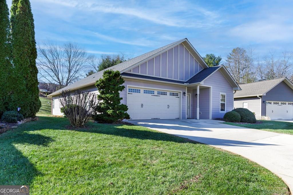 Discover your perfect retreat amidst mountain views, wineries, breweries, rivers, creeks, hiking trails, and the serene Lake Chatuge! This charming home is a delightful haven, meticulously maintained to offer the perfect fusion of comfort and natural beauty. Boasting 2 spacious bedrooms and 2 full bathrooms, this residence is ideal for either full-time living or as a tranquil getaway. Unwind on the expansive back patio, accessible from both the master bedroom and the living room, and immerse yourself in the breathtaking surroundings. Step inside to an open layout with a cozy fireplace, creating a warm, inviting atmosphere. The dining area effortlessly flows into an eat-in kitchen with stainless appliances, which is perfect for casual meals and entertaining, thanks to its convenient breakfast bar. Forget the hassle of upkeep - the Property Owners Association (POA) takes care of lawn maintenance, trash removal and road upkeep, allowing you to fully enjoy the stunning environment. Whether you're searching for a peaceful second home or a primary residence to enjoy throughout the year, this home offers everything you need and more.