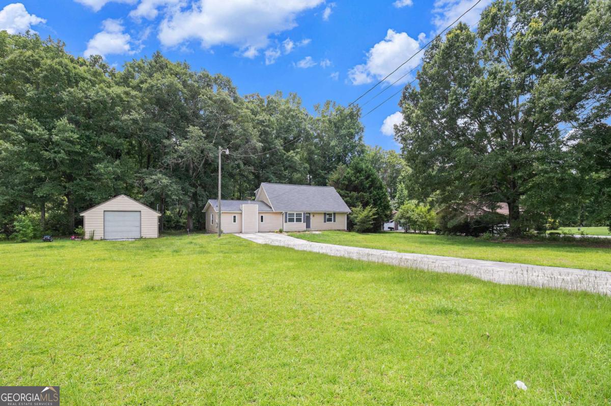Discover this beautifully updated 3-bedroom, 3-bathroom, Georgian-style home, nestled on just over an acre in the desired Newton Ridge community. The inviting main living areas-kitchen, dining, and family room-feature freshly refinished hardwood floors completed in June, adding elegant continuity and a modern bright palette. Step outside to a craftsman's dream: a detached 3033 ft workshop with heated and air-conditioned space, supported by a full 100-amp service panel. This turnkey facility can serve as personal studio space or generate rental income-renters in similar homes fetch about $1,000-$1,200/month, offering a compelling investment opportunity. And there's more-the spacious backyard includes a 1224 shed for additional storage and outdoor convenience. With its large kitchen with abundant cabinet storage, cozy fireplace, private primary suite with dual sinks, and lush level yard, this property effortlessly blends comfort, style, and income potential. Schedule your private tour today!