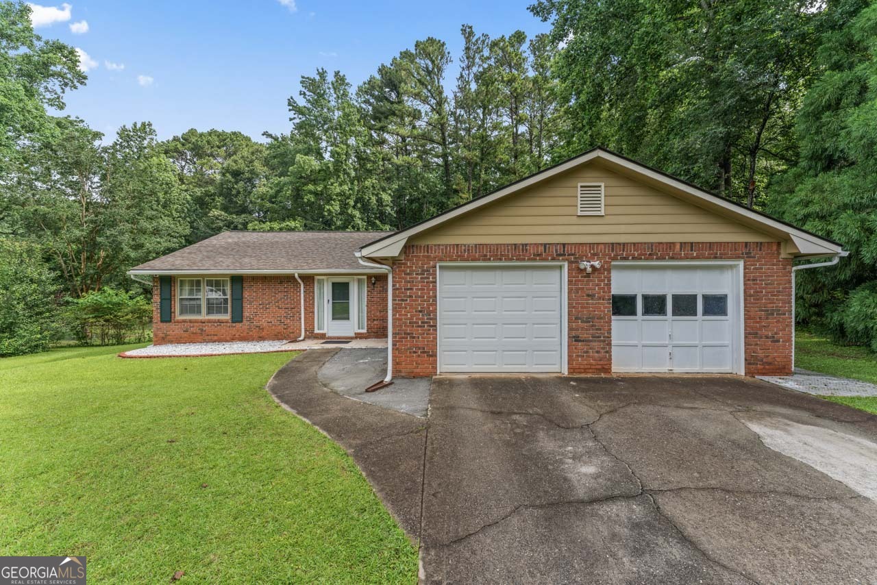Welcome to 1738 Sherry Lane! This charming 4-sided brick ranch-style home, is set on over half an acre lot and offers a private, tree-lined, fenced backyard. This well-maintained 3-bedroom, 2-bath residence features an open floor plan with brand new vinyl flooring throughout. The inviting family room, complete with a cozy fireplace, seamlessly connects to a separate dining area, making it ideal for entertaining. The kitchen is a chef's dream, featuring stained cabinets and solid surface countertops. The spacious primary suite includes two walk-in closets and a bathroom that offers updated countertops and a shower tub combo, creating a tranquil retreat. Two additional guest bedrooms share an updated and remodeled full bath. Step outside to the covered deck, where you can enjoy the seclusion of the fenced backyard, perfect for outdoor gatherings, complete with a fire pit for those cozy fall evenings. This home is conveniently located near Lake Spivey, providing easy access to the interstate, shopping, and dining options. With no HOA fees or restrictions, this home won't last long. Don't miss this fantastic opportunity to make it your own!