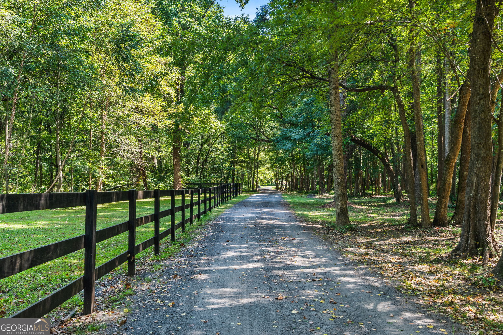 Welcome to your private retreat in the heart of Woodstock - This thoughtfully updated home offers the perfect blend of modern convenience and natural beauty. A welcoming rocking chair front porch overlooks a serene pasture, setting the tone for the tranquil lifestyle this property provides. Inside, the main level features a spacious owner's suite with a beautifully remodeled bath, along with a stylish kitchen featuring updated countertops, appliances, and lighting. The open layout is warm and inviting, designed to flow seamlessly for both everyday living and entertaining. Upstairs, you'll find three comfortable bedrooms, two full baths, and large bonus room offering flexible space. The terrace level is full of potential with a finished full bathroom and ample space to customize to your lifestyle-whether you envision a home gym, theater, or in-law suite. Outdoors, enjoy a large, level backyard complete with a basketball half-court, screened-in porch, and sitting area with fire pit - perfect for relaxing or gathering with friends. What makes this property truly special is its setting. Tate Creek meanders along the long picturesque driveway, adding to the sense of peace and connection to nature. While the home has access to neighborhood amenities - including pool, tennis, and pickleball - it retains a rare sense of privacy and feels worlds away, surrounded by mature trees, starry night skies, and the calming sounds of nature. All of this, just minutes from Downtown Woodstock and Lake Allatoona. A rare combination of seclusion, convenience, and modern updates-this home is a true gem.