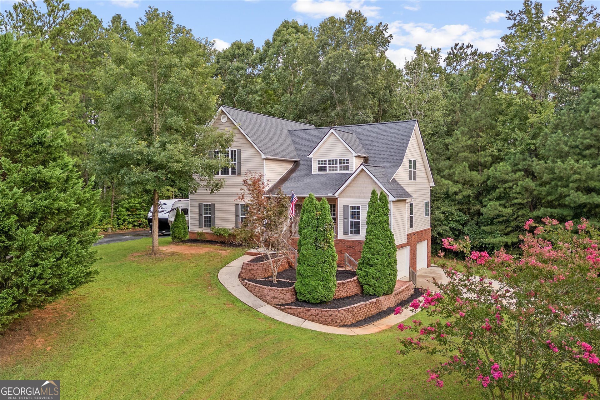 More space. More storage. Less money. This 5-bed, 4.5-bath stunner in The Oaks gives you luxury upgrades, a finished basement, and a private wooded backyard-at a price you won't believe. This corner-lot beauty offers a rocking-chair front porch, spacious living room with shiplap fireplace, and a chef's kitchen with stone counters, island, stainless appliances, and breakfast nook. Main-level owner's suite features a sitting area and spa-style bath. Upstairs-three oversized bedrooms, two sharing a Jack-and-Jill bath, and one with a private bath. Finished basement adds a bonus room, bedroom, and full bath-ideal for guests or in-laws. Enjoy a large 2-car garage, extra storage space next to the garage, two separate driveways, and a private wooded backyard with a deck for relaxing. Zoned for the highly desirable school systems of Whitesburg Elementary, Central Middle, and Central High.