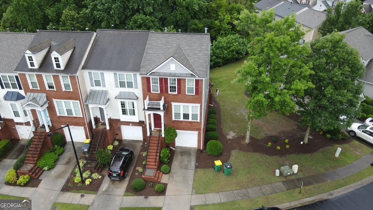 Welcome to 241 Balaban Cir, Woodstock, GA! Fantastic End Unit Townhome in the Desirable Woodlands Community ! This stunning 3-bedroom, 3.5-bathroom end unit townhome features a gorgeous entry that opens to a cozy family room with a fireplace. The large kitchen includes a breakfast/dining area, perfect for gatherings. Upstairs, you'll find dual primary suites with ample closet storage, while the lower-level bedroom and bathroom overlook a serene private green space and trees, providing a peaceful retreat. The property includes a one-car garage with additional driveway parking and a brand-new deck. Roof replaced 2021,2 A/C units both replaced in last few years , water heater serv iced and cleaned in 2024 . Near Woodstock Downtown, Kennesaw State University, Roswell DT and Alpharetta.