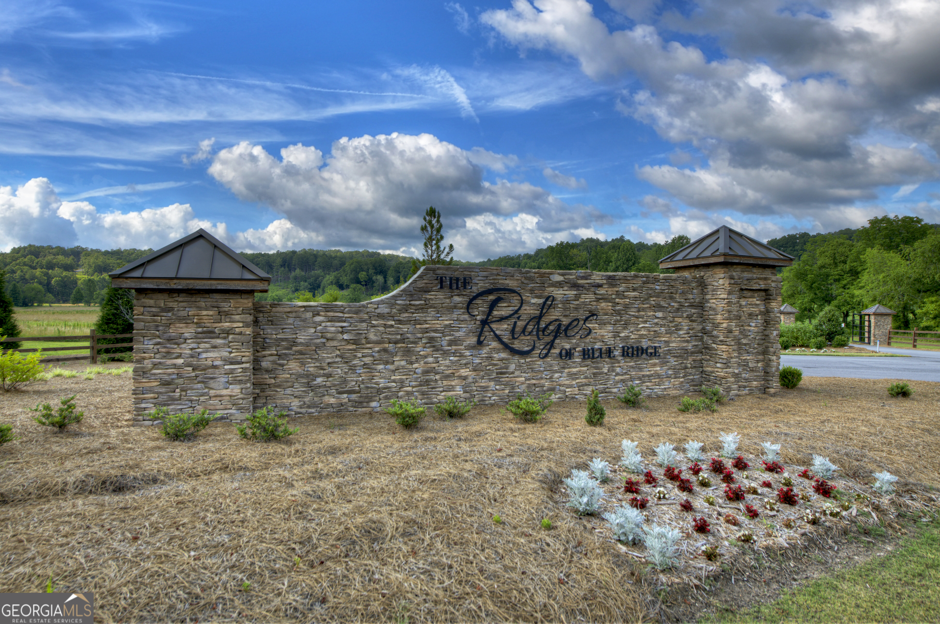 Nestled in a peaceful, nature-rich setting between the charming towns of Blue Ridge and Blairsville, this vacant parcel offers a unique opportunity for your dream retreat. With paved road access and a backdrop of panoramic mountain views, this lot promises both convenience and natural beauty. Whether you're envisioning a weekend cabin or a full-time residence tucked into the serenity of North Georgia, this property provides the ideal canvas. The community is thoughtfully designed with future plans including a clubhouse and swimming pool, perfect for social gatherings or just relaxing after a day exploring the area. A winding creek welcomes you as you drive into the community and a pond borders a portion of the property, adding to the scenic appeal and attracting local wildlife. With a little pruning of some trees, you will be able to see the long range views of our beautiful mountains. Over 20 acres of shared green space offer even more room to roam and reconnect with the outdoors. Nearby attractions include Blue Ridge Lake-ideal for fishing, water sports, or just watching the sun play across the water. For those who prefer their fresh air served with a side of wine or hops, local wineries, vineyards, and breweries are scattered throughout the region. Golf enthusiasts will find several courses nearby, and if you're in the mood for charming local flavor, Kerith House provides a cozy spot to unwind. Here, you'll find the perfect balance between tranquility and adventure, all within a community that values the land and the lifestyle. Bring your vision, your hiking boots, and maybe a fishing pole or two-because life's better with mountain air in your lungs and blue sky overhead