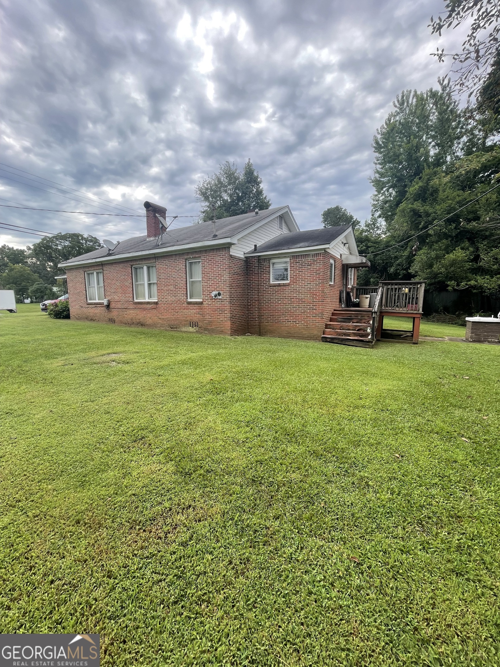 Check out this charming, 3-bedroom, 2-bath brick ranch home, perfectly situated on a spacious lot along Hwy 27. Step inside to discover a home filled with character and potential, featuring nice living spaces, a cozy fireplace, and a functional layout ideal for families or anyone seeking single-level living. Outside, enjoy a big backyard with plenty of room for entertaining, gardening, or simply relaxing on the deck or covered front porch. Whether you're looking for your first home, downsizing, or investing, this well-built home is ready for your personal touch.