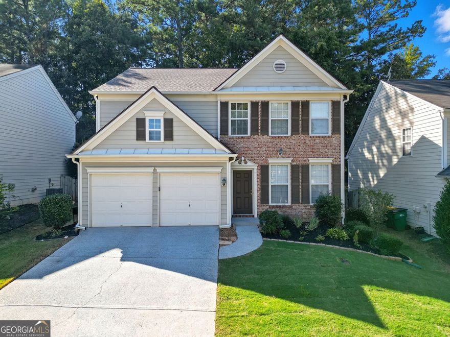 Freshly updated and move-in ready, this two-story home offers space, function, and a smart layout in one of Woodstock's most amenity-rich communities-The Woodlands.  Inside, the main level opens with fresh paint and carpet, updated lighting, and new stainless steel appliances-including a gas range and French-door refrigerator and generous counter space. The dining/breakfast area sits just off the kitchen and flows into the two-story living room where tall windows and a statement fireplace take center stage. There's also a formal dining or home office, a second sitting room at the front, and a half bathroom tucked away for guests.  Upstairs, the primary suite offers vaulted ceilings, a large walk-in closet, and a bath designed to recharge with a garden tub, separate shower, and dual vanity. Two additional bedrooms share a full hall bath, and the laundry room is conveniently located on the same floor. All bedrooms and stairway feature brand-new carpet.  Step outside to a private, level, fenced backyard with a large patio-ready for cookouts, a fire pit, or simply relaxing. This home also comes with a new roof, new HVAC, termite bond, and kitchen-level parking.  The Woodlands offers an Olympic-sized pool with waterslide, a second pool, clubhouse, fitness center, 10 tennis courts, plus basketball and volleyball courts, miles of wooded trails, and a sprawling playground and sports field. Just minutes from Downtown Woodstock and surrounded by grocery stores and dining options, this location is as practical as it is fun.