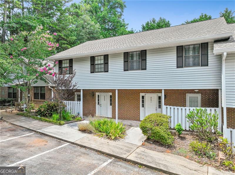 WELCOME HOME!! 3 bed 2.5 bath two story townhome in Norcross accessible to everything!! As you walk into the light filled foyer you have the half bath just for guests ad a hallway closet! Keep walking into the open floor plan living room with brick fireplace, dining room space, and UPDATED kitchen Stainless steel countertops, glass tile backsplash, upgraded GAS STOVE & Oven 5 burner you just don't see that in these units ever - ALL APPLIANCES STAY WITH THE HOME! Living space overlooks the sunroom with utility closet storage and green space behind the home! Just off the kitchen is a hallway to the laundry room and mudroom with second entry making it so easy to bring your groceries inside! As you head upstairs you'll notice the two story stair well with crystal chandelier. Master suite has its own full bathroom and an entire wall of closet space! Two other great sized bedrooms with hallway full bathroom there is space for everyone! ENTIRE INTERIOR has been painted & new LVP flooring throughout! This place is truly turn key & one year home warranty is provided for ease of mind! Wintergreen community includes Pool and Dog Park! TWO PARKING SPOTS Close to I-85 Buford Highway, super H mart, multiple Jaliscos, and coveted Gwinnett County parks *Best Friend Park is my fav* Ask me how we can get you up to $3,000 towards closing costs!