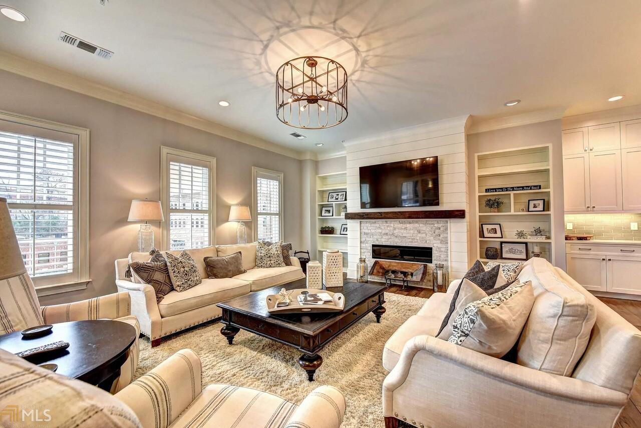 Spectacular 3 bed/3.5 bath home in Teasley Place, downtown Alpharetta's most desirable address. Completely secure building utilizes the latest technology and and Control 4 home automation! The ultimate in modern open plan living with the highest quality in every detail. 7" Wire brushed hardwood floors, 10 ft ceilings and oversized 8' windows throughout. Truly gourmet kitchen with Wolf and Sub-Zero appliances, Quartz countertops, a large island and high-end custom cabinetry. Beautiful family-sized dining room with crown molding. The warm and inviting family room  features a modern brick fireplace with shiplap surround and distressed wood mantle, custom-built-in bookshelves and wall of windows overlooking downtown Alpharetta. The romantic master suite features French doors to the stunning covered balcony, the perfect place to enjoy your morning coffee or evening sundowner. The opulent master bathroom features custom tile work in the oversized shower and herringbone tile floor, a deep stand alone tub, double vanity, marble countertops and huge walk-in custom closet with custom shelving. 2 additional large secondary bedrooms with luxurious en-suite bathrooms featuring high-end cabinetry and custom tile work on the floors and showers. Convenient office space with pocket doors and custom shelving and cabinetry. Enjoy the views of downtown Alpharetta from the covered balcony with fireplace and built-in gas grill. Amenities include over 1/2 an acre of outdoor living that features a dog park, outdoor kitchen, fireplace and entertaining areas, fire pit and gym. Enjoy a variety of restaurants and stores right at your door step. Teasley Place also features a concierge, gated homeowner parking and plenty of guest parking. Welcome home...