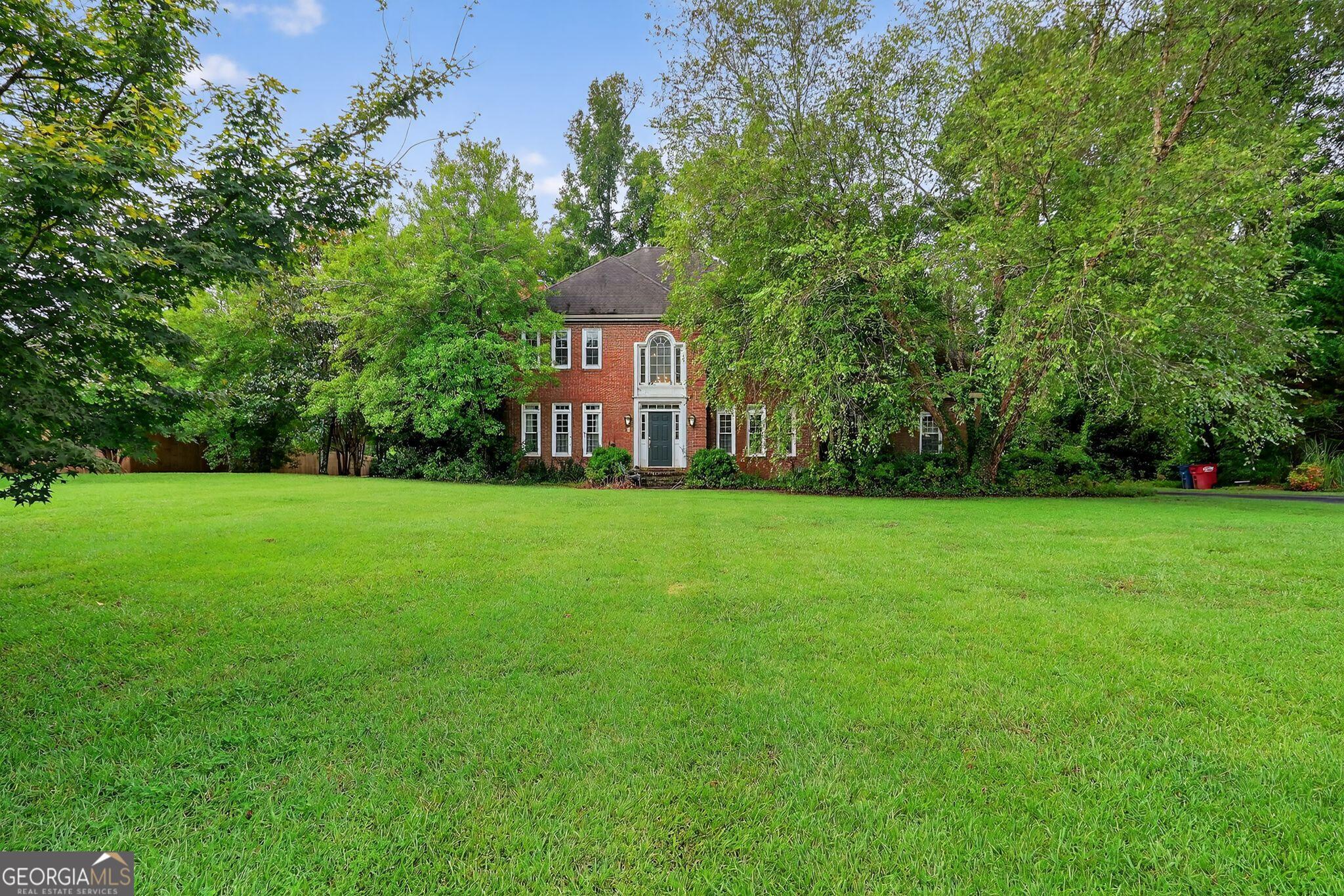 Welcome to 118 Ashford Park, a beautifully maintained 4-bedroom, 4.5-bath home located in one of Macon's most desirable neighborhoods. This spacious home offers the perfect blend of elegance, comfort, and functionality-for both everyday living and entertaining. Step inside to find hardwood floors throughout the main level, adding warmth and charm to the open, inviting layout. The heart of the home is the updated kitchen, featuring stainless steel appliances, granite countertops, a large kitchen island, and a cozy breakfast nook-a perfect space for casual meals or hosting friends and family. You'll love the separate formal dining room for special occasions, and the dedicated home office with custom built-in bookshelves provides a quiet space to work or study. Enjoy year-round comfort in the screened-in back porch, overlooking the large, level backyard for outdoor activities, gardening, or simply relaxing. With four spacious bedrooms, each with access to its own bathroom, this home offers plenty of privacy and convenience. The layout is thoughtfully designed to provide extra space for a family of any size. Don't miss your chance to own this beautiful home in a prime location.