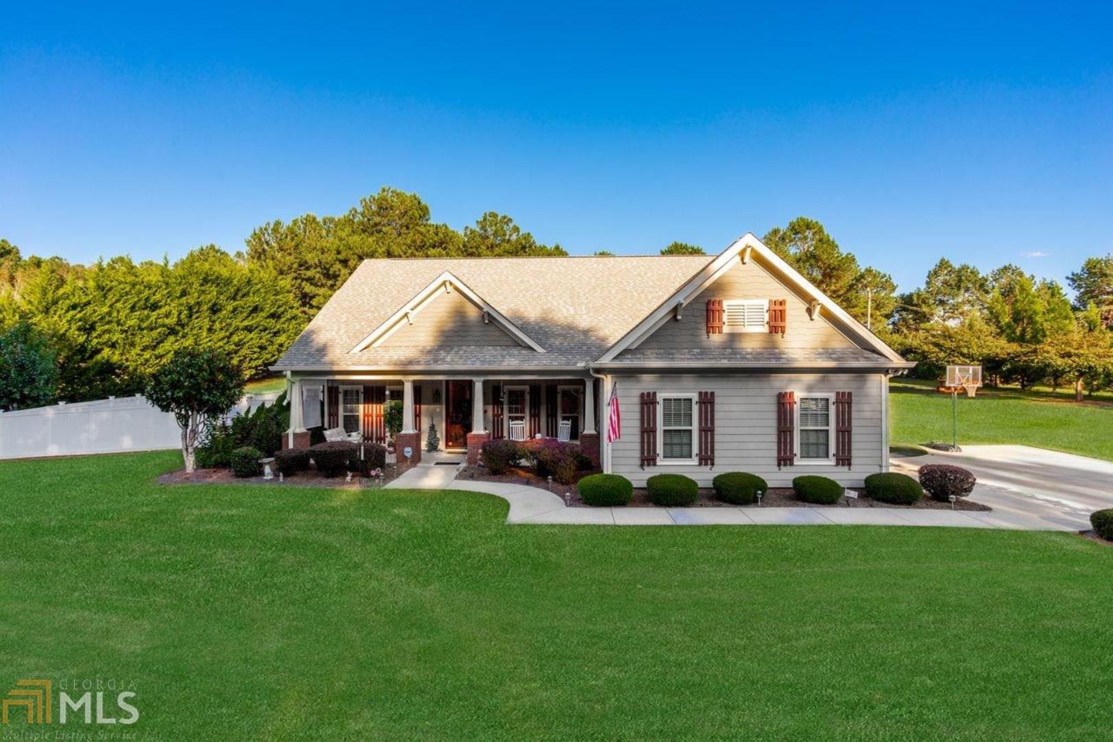 This GORGEOUS lot (1.65acres!) will blow you away. It is such a perfect lay of land and as peaceful as they come.Welcome to this lovely well maintained craftsman style RANCH, w/ a welcoming front porch, grand oversized entryway,upscale trim package, and gleaming hardwood floors.The ceiling height is fabulous and really makes the space feel large and airy. Oversized stone fireplace and a screened in rear porch are just a few of this homes appointments.Partially fenced area for garden parties or pets.Large Outbuilding/garage in back.Unfinished bonus room could be 4th bedroom if needed. This home is a winner! NO HOA, Hard to find perfect ranch on acreage. Convenient to Lake Lanier and Downtown Gainesville. BACK ON MARKET, BUYER FAILED TO CLOSE.