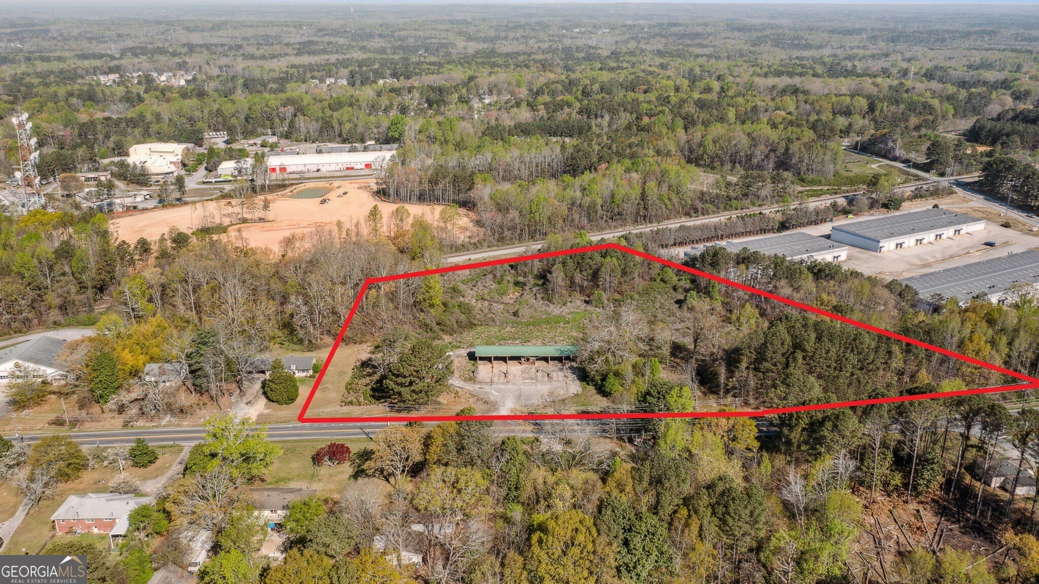 Presenting an unparalleled commercial opportunity in the heart of Douglasville, GA. This expansive 7.46-acre parcel of land offers prime visibility along the bustling US-78 Highway. It boasts 899 feet of road frontage and displays to 11,200 vehicles per day. With its rolling terrain and historic remnants of a former car wash, it features a 200-foot well that provides a unique canvas for your entrepreneurial vision. Adjacent to an active railroad, it's perfectly positioned for businesses requiring railhead access, opening doors to a range of possibilities from mixed-use retail outlets and restaurants, to hotels, automotive services, professional business parks, open parking lots - all zoned for general commercial use.