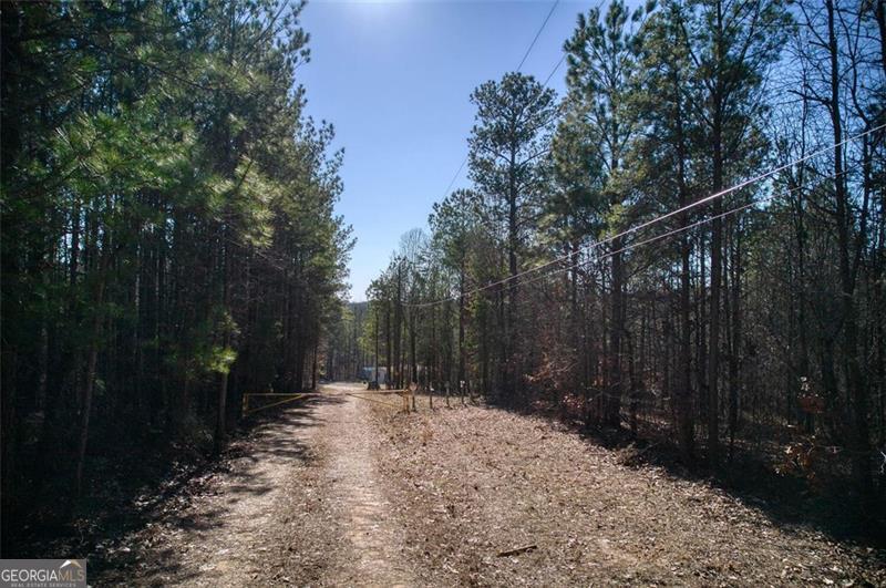 Just minutes from Highway 278, this 13.37-acre residentially zoned build site offers the perfect balance of privacy and accessibility. Nestled among a peaceful mix of mature hardwoods and towering pines, the land features a beautiful combination of flat and gently sloping topography-ideal for a variety of home sites and layouts. With two wells, two septic systems, and electric already on site, much of the groundwork has been done for you. Whether you're dreaming of a secluded custom home, a rustic cabin retreat, or space for multiple dwellings, this property is ready to bring your vision to life. Enjoy the quiet and calm of country living without being too far from town-this is a rare opportunity to own a versatile piece of land in a naturally stunning setting.
