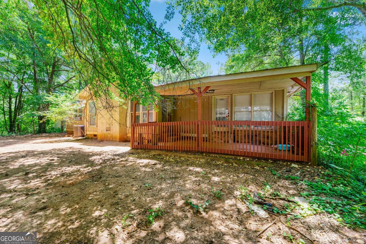 Solid Opportunity on Over 3 Private Acres! This 3-bedroom, 2-bath ranch offers strong bones, recent major upgrades, and endless potential. Featuring a newer roof, HVAC, and well, the home is ready for your finishing touches. Inside, you'll find a spacious floor plan with vaulted ceilings, a dramatic floor-to-ceiling stone fireplace, and a split-bedroom layout perfect for privacy. Whether you're looking for a great flip, a rental, or your next primary residence, this property fits the bill.
