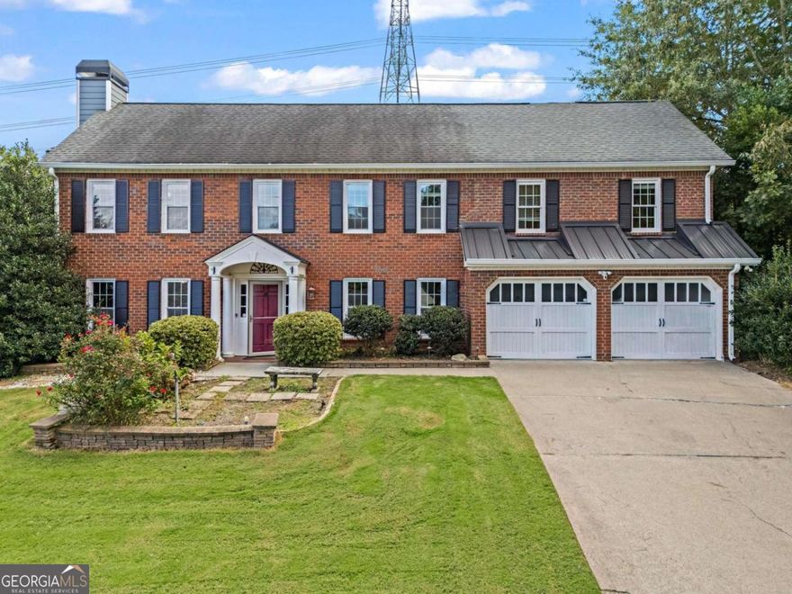 Welcome to this beautiful brick home in the highly desirable Walton School District. Perfectly situated in a sought-after neighborhood offering tennis courts, a swimming pool, and a scenic lake for fishing, this property combines location, lifestyle, and comfort.    The interior boasts a spacious and functional layout. A large kitchen with an oversized island serves as the heart of the home, opening seamlessly to the expansive living room with a cozy fireplace. On the main level, a generous bonus room includes its own private hot tub-an ideal retreat for relaxation or entertaining. Upstairs, four bedrooms provide plenty of space, along with a flexible bonus room that makes an excellent media lounge, game room, or teen hangout, complete with a balcony overlooking the backyard.    Outdoor living is a true highlight. Step from the living room onto a screened-in porch, perfect for morning coffee or unwinding in the evening. The large, fenced backyard is designed for entertaining, featuring a built-in stone fireplace with seating, lush green space for play, and plenty of room to host family and friends.    This home offers the perfect blend of indoor comfort and outdoor enjoyment in one of East Cobb's most coveted communities.