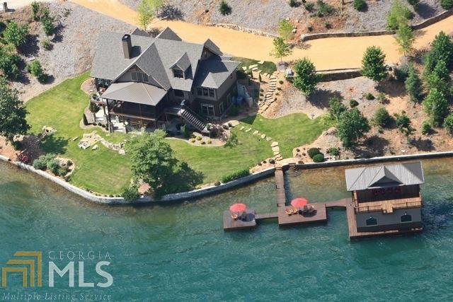 20 years of entertaining on this coveted main body lot were carefully considered prior to crafting this gorgeous 6BD, 6.5ba custom home, resulting in the ultimate prototype for the perfect lake house. Every nook and cranny was taken advantage of, including a magical "Narnia" room hidden behind a bookcase. Features include an open great room, designer chef's kitchen, spacious screened porch with sweeping lake & mountain views, master on main, terrace level family room with billiards and wet bar, guest suites with built-in bunk beds, protected swim area and 350 ft of lake frontage on deep water.