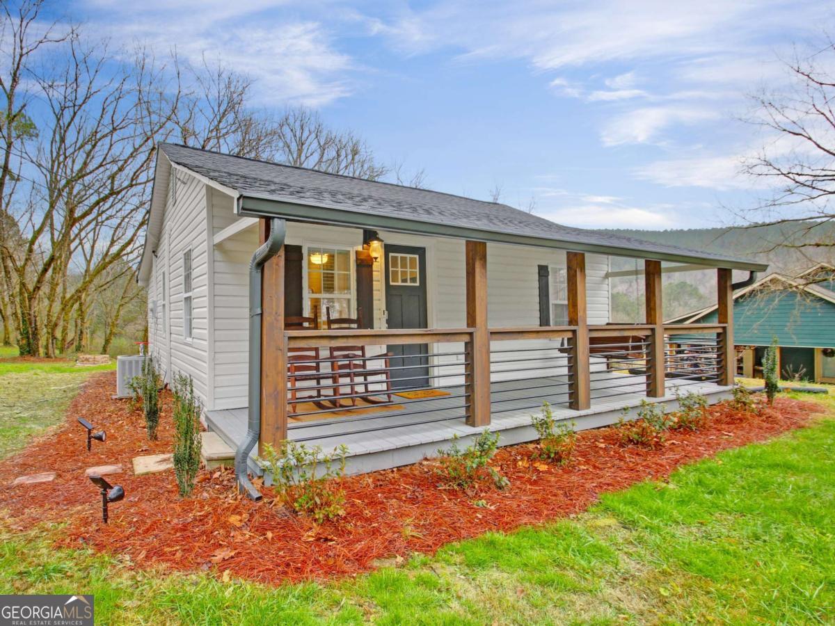 Welcome to your turnkey retreat in the heart of Historic Downtown Talking Rock! This fully renovated 2-bedroom, 1-bath cottage offers the perfect blend of charm, comfort, and convenience. Originally built in 1953 and thoughtfully updated in 2021, the home features an open and inviting layout with stylish finishes throughout. Inside, you'll find a bright living area with easy flow into the modern kitchen, complete with updated cabinetry and appliances. The spa-like bathroom and comfortable bedrooms make the most of the home's footprint, while luxury vinyl flooring and updated lighting add a fresh, polished feel. This property is being offered fully furnished-including dcor, window treatments, and even a hot tub-making it truly move-in ready or an ideal short-term rental investment. It is currently on a rental program. Set on a half-acre lot, the home provides outdoor space to relax and enjoy the peaceful setting. The private hot tub is the perfect spot to unwind after a day exploring all that North Georgia has to offer. Whether you're looking for a full-time residence, a weekend getaway, or an income-producing property, this one checks all the boxes. The location is unbeatable-just steps from the charm of downtown Talking Rock, five minutes to Jasper for shopping and dining, and minutes from all of the North Georgia wineries, hiking trails, and outdoor adventures. Don't miss this rare opportunity to own a beautifully updated cottage in one of North Georgia's most charming historic towns.