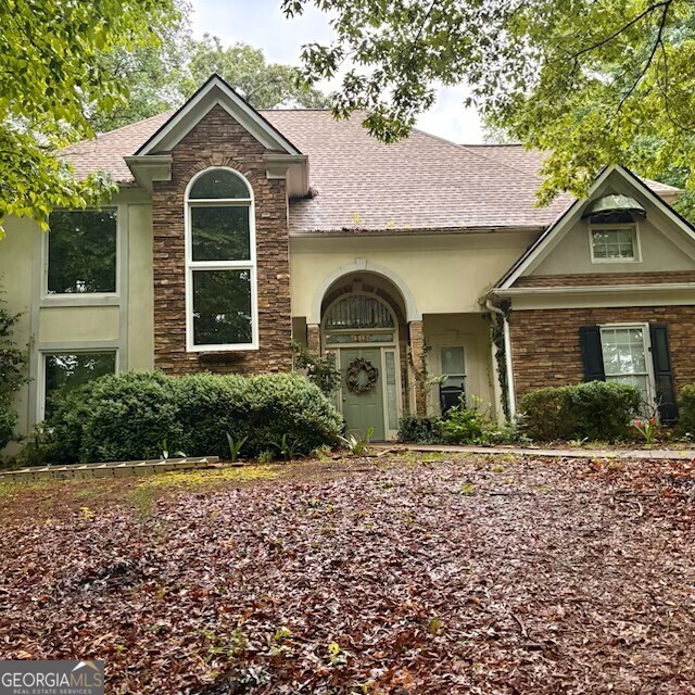 NEW PICTURES: Bring the horses! Location is key. Great schools, no HOA, 2 acres, and more. The house sits on prime 2 acres with beautiful trees and has a great floor plan. The master suite is on the main, there is a half bath on the main for guest and upstairs are 3 more bedrooms with 2 bathrooms. Behind the house is a one bedroom/one bath apartment complete with a kitchen for guests, rental, family or office space. It has multiple ways to be used depending on what is going on with your life. Across the street there is a Wild Mustang Rescue ranch. This property is protected and will be home to Wild Mustangs forever. Call Kim Wilcox for an appointment to see this home. Her number is (404) 713-6572. Both house and apartment are lived in and will need a 48 hour notice before showing. Both the home and apartment have people living in them. Plus, there are dogs to get out of the house.