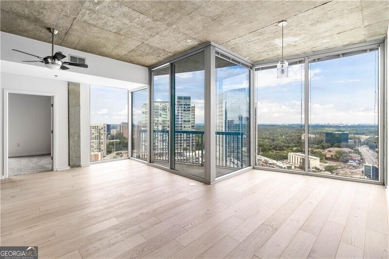 FHA APPROVED. Welcome to The Realm! This stunning 2 bed, 2 bath unit boasts breathtaking views of Buckhead's skyline through floor-to-ceiling windows. Fresh paint throughout, brand new European oak hardwoods, and brand new carpet in bedrooms create a bright and modern atmosphere. Enjoy top-notch amenities, 24-hour concierge service, and unbeatable walkability to Buckhead's finest dining and shopping. Plus, walk to MARTA for easy access to the city. Don't miss this incredible opportunity!