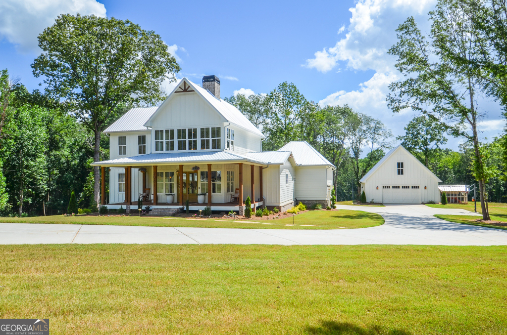 Welcome to paradise! This stunning 10 Acre estate has it all, 3 bedroom and 2 1/2 baths in the main house. The Detached includes additional living area/man cave. It has 1 bedroom, 1 bath and a kitchen. This beautiful home has tons of windows with natural light, open concept, 10 foot ceiling height downstairs with oversized 8' tall doors. The oversized Chefs kitchen features premium finishes, a large 8' x 5' island, a Kutch gas stove and oven, custom maple vent hood, Quartz countertops and a pot filler. Kitchen also has a farm house sink, lots of cabinets with a separate Butlers pantry with wine/beverage cooler. Primary suite on main, custom primary closet, primary bath includes double sinks, separate freestanding tub, and tiled shower with a rain head. This home also includes a mud room, LVP flooring through entire home, and covered front and back porches. Breathtaking custom full height, all brick, double sided wood burning fireplace! Upstairs features two large bedrooms with jack and Jill bath. Double sinks with quartz countertops and a separate shower and toilet room. Both upstairs rooms have large walk in closets. Spacious tiled laundry room with cabinetry for storage. Large Salt water, Gunite, 8' deep pool. Pool features spillover, heated spa with 6' tanning ledge. Outdoor speaker system around pool for all your pool parties. Irrigation surrounding pool and main house. 1/2 acre pond and 600' of creek access on rear of property. ATV trails cut on back of property. Pond has power access. This home has it all... If that's not enough, this property also features a custom matching chicken coop with rear overhang storage for tractors etc. Room for gardening, horses or cows. 300' long double car driveway with 2 turnarounds. Custom brick and wood entrance with lighting. Entire house and detached has insulated spray foam insulation for high energy efficiency. Home is on Crawl space, that is entirely heated/cooled and encapsulated. Landscape lighting on front of home. Property is currently in land conservation for property tax savings. Located minutes to downtown Jefferson and a 20 minute drive to Athens.