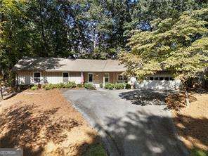 Just listed in Kingsley neighborhood in Dunwoody! This charming, completely renovated ranch is the one you've been waiting on! Walk into a dedicated foyer space and you'll immediately notice the thoughtful updates that the current owners have made during their ownership - hardwood floors throughout, recessed lighting, new interior doors and hardware. The open concept kitchen with living room makes this such a special home - the kitchen was updated with love in 2022 with gas range, custom vent hood, all new stainless steel appliances, white cabinetry, farm house sink, updated backsplash, and quartz countertops. There are 2 secondary bedrooms that share a renovated hall bathroom. The oversized primary bedroom features an en-suite bathroom (newly renovated in 2024) with Carrera marble tile, frameless shower, double sink vanity, and walk-in closet. Two generous secondary bedrooms share an updated hall bathroom. There's tons of extra storage throughout, including a dedicated laundry room/ mud room. The roof was just replaced 4 years ago. Enjoy year-round outdoor entertaining on the front porch or four season sunroom and a private, fully fenced-in backyard is perfect for your pets!