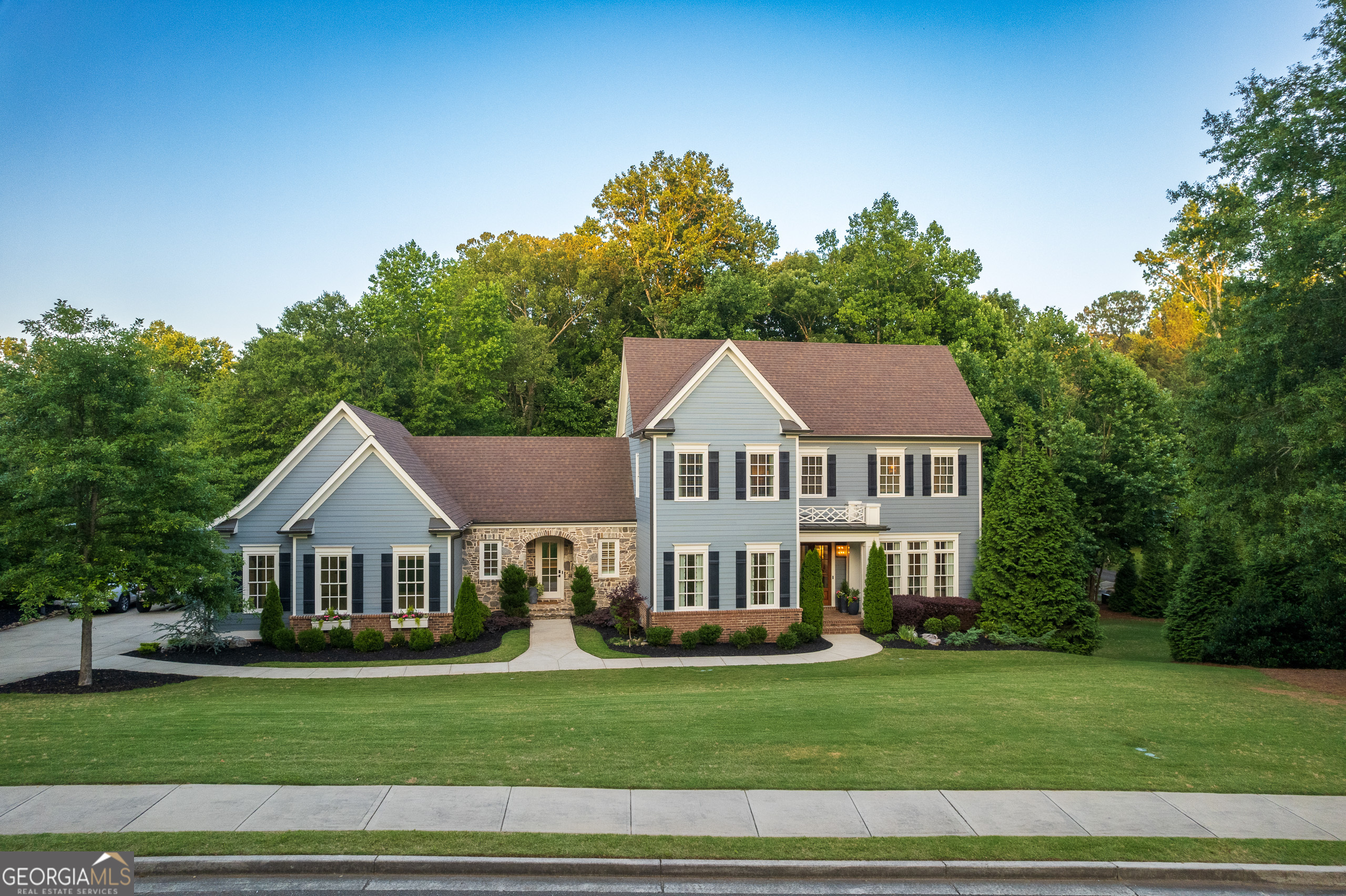Introducing a custom-built home that redefines luxury living with exceptional design, spacious living areas, and a tranquil setting surrounded by a 160-acre nature preserve. The main level is thoughtfully designed for both comfort and entertaining, featuring an open concept layout, a stunning 17-foot kitchen island, premium Thermador appliances, a walk-in pantry, a butler's pantry, and multiple dining areas perfect for hosting gatherings. Upstairs, the private primary suite is a true retreat, complete with two generous walk-in closets, a dedicated laundry space, and a spa-inspired bathroom adorned with Carrara marble accents. Oversized secondary bedrooms provide plenty of space and comfort for family or guests.    The terrace level offers the ultimate in entertainment, highlighted by a wine room with built-in display shelving, lighted bar cabinets, and refrigeration. Double French doors open to a spacious covered patio featuring a stone fireplace and overhead heating, allowing for year-round outdoor enjoyment. The home theater elevates movie nights with a 130-inch screen and tiered seating for a cinematic experience like no other. With fresh exterior paint, a new HVAC system, gutter guards on the rear of the home, and set amidst lush landscaping in a quiet neighborhood, this home is a rare find, blending high-end upgrades with natural beauty. Don't miss your chance to own this exquisite property and experience luxury living at its finest.