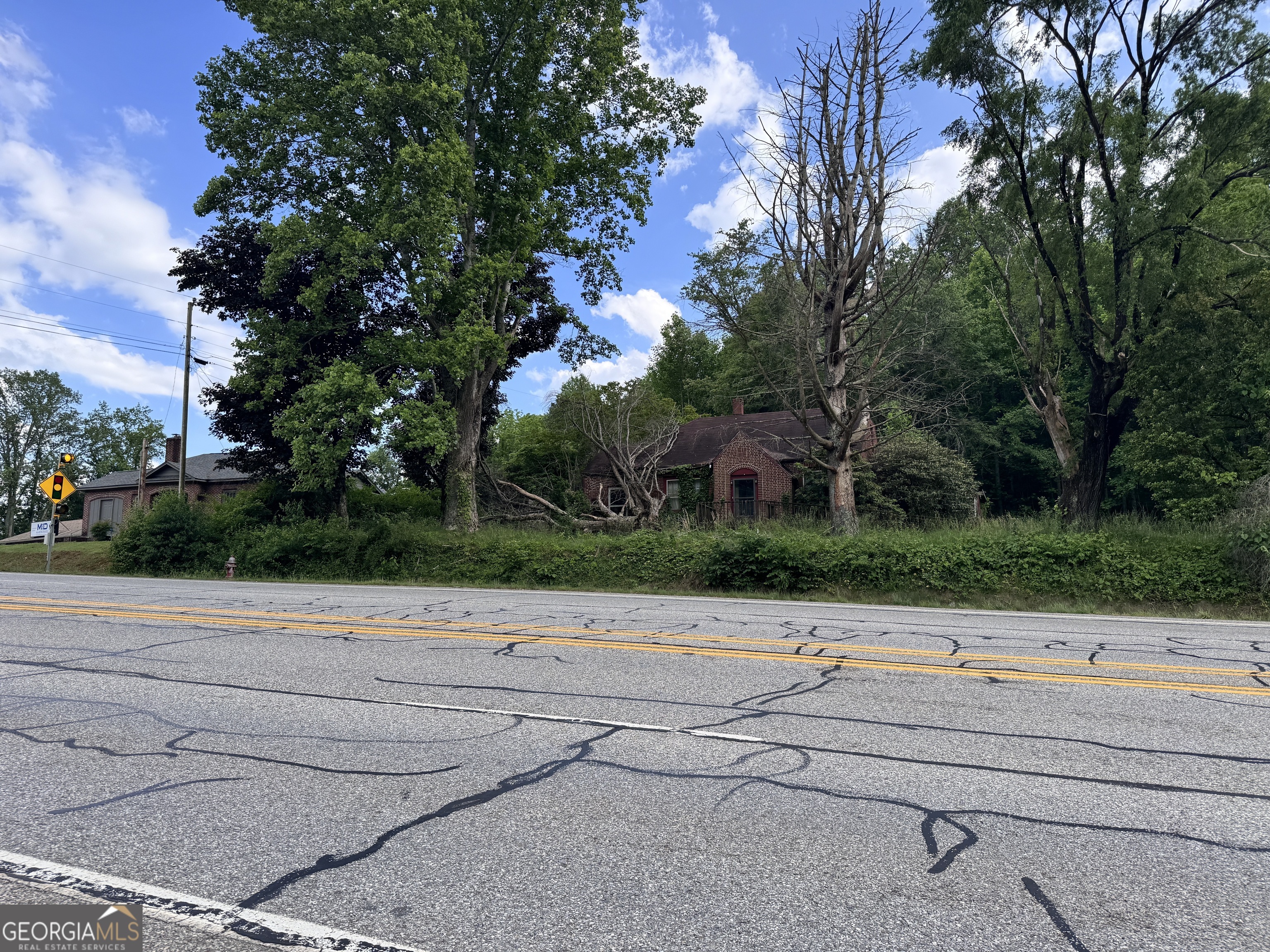 SELLER FINANCING AVAILABLE!!! Prime Commercial Opportunity in the Heart of Hiawassee - Approximately 284' of Road Frontage! Location. Visibility. Potential. This 1.52-acre property offers unmatched exposure with about 284 feet of coveted commercial road frontage in the charming mountain and lake town of Hiawassee, Georgia - a thriving destination for tourists, adventurers, and locals alike. Whether you're dreaming of opening a boutique, restaurant, coffee shop, professional office, or a mixed-use development, this property delivers the perfect canvas. A brick structure currently sits on the lot, offering options: remodel and repurpose, or start fresh and build your vision from the ground up. The structure requires a full renovation or removal, making way for endless possibilities. Multiple potential uses, this lot is a rare gem that caters to investors, developers, and business owners looking to make their mark in a town that's growing in popularity year after year. Key Highlights: - 1.52 acres of mostly level land - 200+ feet of high-visibility road frontage - Existing brick building (needs complete rehab or teardown) - Flexible zoning: Residential or Commercial - Surrounded by the natural beauty of the North Georgia mountains and Lake Chatuge Don't miss your chance to secure one of Hiawassee's most versatile and visible commercial properties. This is more than land - it's a launching pad for your next big idea. Bring your vision and unlock the potential of this rare mountain-town investment.