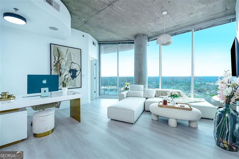 Priced to sell - Welcome to The Twelve Atlantic Station No. 2122! Luxury corner unit condo boasting breathtaking and unobstructed city views, this residence offers the finest in high-rise living with state-of-the-art amenities and exquisite upgrades throughout. Step inside to find brand-new luxury plank flooring and fresh paint throughout, creating a sleek and contemporary ambiance. Floor-to-ceiling windows flood the space with natural light, while the open-concept layout enhances the sense of space and grandeur. The gourmet kitchen features high-end stainless steel appliances, granite countertops, and custom cabinetry, seamlessly flowing into the spacious living and dining areas-perfect for entertaining. The primary suite boasts a custom walk-in closet and spa-inspired en-suite bathroom, complete with a soaking tub, rainfall shower, and designer finishes. Residents enjoy world-class amenities, including a 24-hour concierge, resort-style pool, fitness center, club lounge, and private parking. Located in vibrant Atlantic Station, you're steps from Atlanta's best shopping, dining, and entertainment. This move-in-ready condo is available with negotiable designer furniture, making it the ultimate turnkey luxury home. Schedule your private showing today!