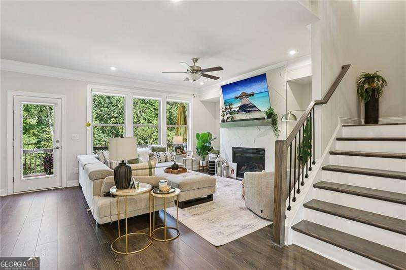 You found your new home!! Amazing location in Roswell. Just two miles from Canton Street, five miles from the Avalon in Alpharetta, minutes from golf courses, shopping, restaurants, Chattahoochee River, parks and the Ga-400. This beautiful home puts you close to everything and still maintains the serenity of suburban life. From the very first step into the home, you're greeted with upgraded hardwood floors, surrounded by a beautifully balanced contemporary design, a dining room filled with light that flows into the white quartz countertops and kitchen surrounded by 9ft ceilings. In the kitchen, you have an island that provides ample seating to entertain guests, cook, and eat. Custom cabinetry in the walk-in pantry offers more storage for all your kitchen needs. As you flow from the kitchen, you're welcomed by a living room that has not only a fireplace, space for an office but also direct access to a private back porch with nothing but trees and woods to meet your gaze. Here you have absolute peace to sit, drink your tea and be greeted by the sunset in the afternoons. Upstairs, the primary master bedroom offers an amazingly spacious walk-in closet, a dual vanity for both parties to have their space and an oversized shower enclosed by glass. The additional bedrooms also have their own deep closets and are equally gifted by natural light. The laundry room is conveniently on the upper level with its own custom cabinetry for additional storage. On the terrace level, you'll have direct access to an additional room with a full bathroom for a variety of uses for guests, entertainment, exercise room, and more. The terrace level has direct access to the garage with a custom mudroom to greet you back for seating, storage and shoe placement.