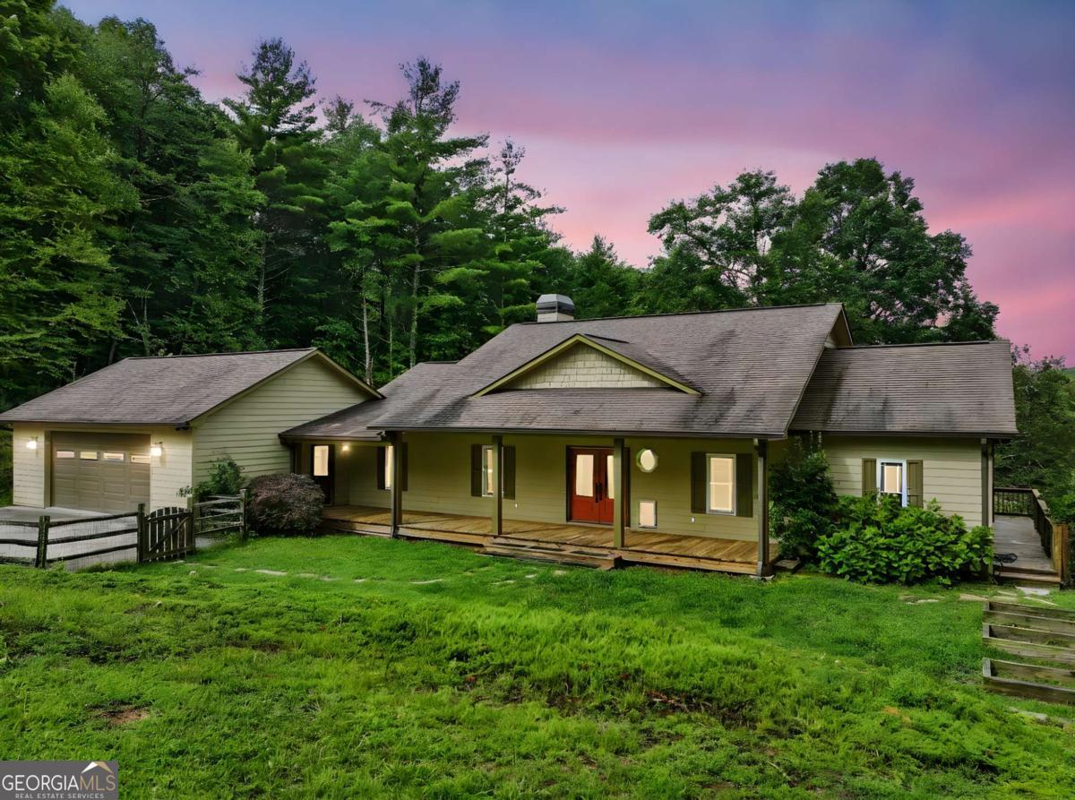 Sprawling 5-bedroom, 3-bathroom ranch-style home situated on over 3 acres of peaceful countryside. Step inside to discover an open and inviting layout with generously sized bedrooms, a spacious living area, and a well-appointed kitchen with ample cabinet space and butler's pantry. The full finished basement features a second kitchen, full bathroom, and multiple flex spaces - perfect for extended family, guests, or entertaining. Additional highlights include a primary suite with ensuite bath on main level, a covered rocking chair front porch and back screened in patio. Tons of storage throughout and ample parking room for boat or RV. Outside, you'll find even more to love: a large 2 story second garage with a full workshop offers an additional 1500 sq/ft, ideal for hobbyists, car enthusiasts, extra storage, or even a storm shelter. The workshop features concrete walls and steel trusses with a concrete ceiling. The expansive lot provides privacy, plenty of space for recreation, gardening, or even future expansion. Enjoy country living with all the conveniences just minutes away. Whether you're looking for space to grow, work from home, or simply relax - this property offers it all! Don't miss your chance to own this unique and versatile estate - schedule your private tour today!