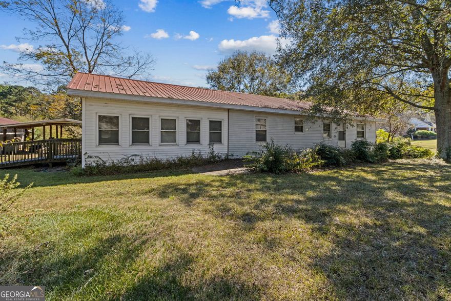 Cash Only-Will Not Qualify for Financing.  Super rare opportunity to own beautiful acreage in the sought-after Appalachee School District! This peaceful property features a simple homeplace nestled beneath gorgeous shade trees-ready for a total renovation to make it your own or the perfect site to rebuild your dream home. The existing structure offers potential for 4 bedrooms and 2 full baths with handicap ramp access. Enjoy quiet evenings on the back porch overlooking the serene property. Outside, you'll find a large carport, 2-bay shop, spacious pole barn, rustic barn, and open pasture. With approximately 313 feet of road frontage, the possibilities here are endless!