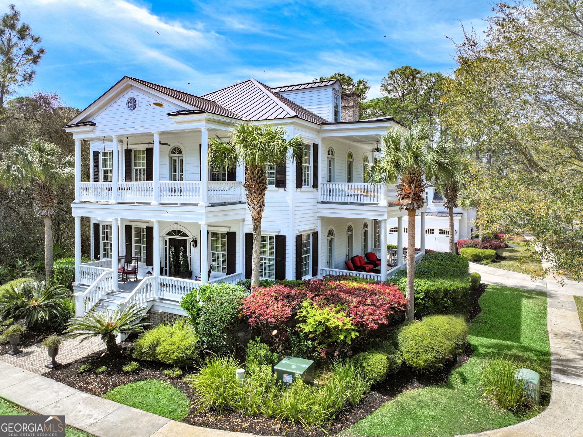 A dream home with an architectural Greek Revival look in Cumberland Harbour subdivision in St Marys, GA. This home will be beyond your expectations and will leave you speechless as you walk in the foyer facing the majestic 11' high ceilings, crown moldings, carved casings around the doorways, coffered ceilings and hand scraped hickory plank wood floors. The features and details of this home cannot be described in words, you must experience it to appreciate the architectural designs in this one-of-a-kind home. Main floor has a large foyer that leads to a formal living room on the right and formal dining room on the left. Both with coffered ceilings, crown moldings, and chair railings. From the foyer you will face the beautiful stairs that lead to the second floor which has 3 bedrooms, 3 baths and a loft area that can be used as a library. Each bedroom has private full bath. Double doors open to a true master suite with sitting area, large master bath featuring double vanity, tub, shower and walk-in closet. On the first floor a wide hallway from the foyer leads to a large family room with full masonry fireplace with gas hook up and a cook's dream kitchen with granite counters, stainless steel appliances, an island bar, gas stove and butler's pantry and overlooks the inground pool and garage apartment. Detached two car garage features the 4th bedroom with tastefully furnished 650 sqft included in listed square footage with a full bath and kitchenette. Great option for separate lodging for out-of-town guests. Wrought iron fenced yard. Sprinkler system, each building has on demand water heater, plantation shutters throughout. Metal roof and porches on the front and back of the home.no flood insurance required on this house. Gated community, agent must accompany buyers when viewing.