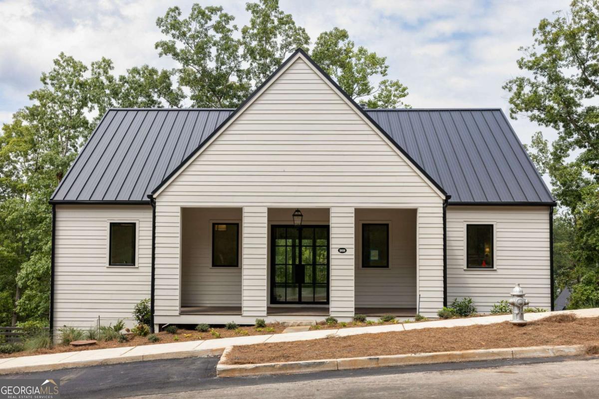 Perched high on the Lupo Loop ridge-line, this Phillip Clark Custom Homes masterpiece captures sweeping sunset views and effortless indoor-outdoor living. The open floor plan showcases vaulted ceilings in the living room and on the spacious back porch, while the main-level primary suite offers convenience and comfort. An expansive front porch welcomes you home, and the terrace level provides guest bedrooms, a second living area, and an additional back porch designed for year-round entertaining. Just a short distance from shops and a plethora of wellness amenities, this home is turn key and ready for you to call home. Immediate access to over 20 miles of soft surfaced nature trails right outside your front door.