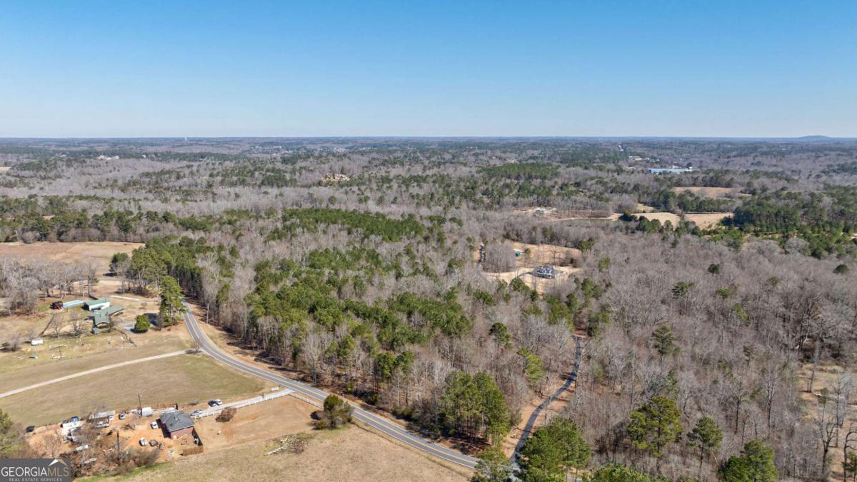 Discover Lot 5, an enchanting 11-acre parcel located in Loganville, GA, along the attractive Kent Rock Rd. Where large beautiful estate homes are coming up left and right. This property is characterized by its serene surroundings and excellent potential for your dream project. With ample road frontage (1500 feet) and easy access to county water, this lot offers both convenience and flexibility. Imagine the possibilities. Whether youre seeking to create a private estate or exploring opportunities to subdivide for a family compound, this lot meets all your needs. Its prime location allows for a seamless commute, just a quick drive to Highway 138 and Highway 78. The property is just a short ten-minute drive from downtown Loganville and a fifteen-minute drive to Monroe. This versatile parcel allows for future subdivision into smaller lots, making it perfect for developing a family compound or investment opportunity. Enjoy the proximity to numerous amenities: a mere three miles to the nearest hospital, minutes from the vibrant communities of Loganville and Grayson, and a twenty-mile drive to the breathtaking sights of Stone Mountain and twenty-minutes from Arabia Mountain. Adventure and tranquility await offering a unique escape into nature. Seize the opportunity to create your vision on this unparalleled piece of land.