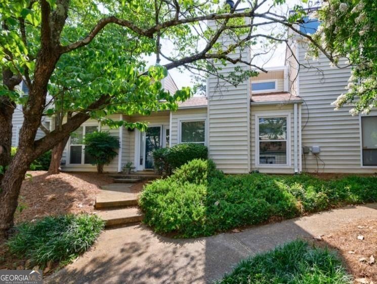 Welcome to a remarkable opportunity to own a truly exceptional townhome. The unit is located in a very quiet and secluded part of the community. It is completey renovated/updated and is move in ready. As you enter the foyer, the soaring ceilings and carefully curated light fixtures will beckon you inside. Once inside, the open-concept layout offers a seamless flow from one room to another, enhancing the livability and versatility of the space. The living area is filled with natural light, thanks to strategically placed windows that really illuminate the space. The kitchen, often referred to as the heart of the home, is a culinary delight. Featuring an array of modern appliances, ample counter space, and an abundance of cabinetry, it provides an ideal environment for both the novice cook and the seasoned chef. The design encourages social interaction, allowing family and friends to gather around the spacious island while culinary creations come to life. The master suite, a sanctuary unto itself, is a splendid retreat that features an en-suite bathroom replete with luxurious finishes, offering a spa-like experience that invites relaxation. The additional bedroom is equally impressive, along with the newly updated guest bathroom. There is also an unbelieveably large fenced-in patio, that has a deck and grill connected to the natural gas line. An opportunity like this does not come often, and it stands ready for the discerning buyer who values the exquisite balance of style, comfort, and quality. Don't miss your chance to make this extraordinary property your new home, where every corner invites you to create lasting memories.