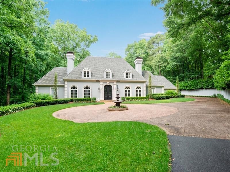 Truly breathtaking gated estate on a private 4+/- acres. Spacious main level floorplan offers oversized living spaces ideal for entertaining. Grand entrance foyer leads to handsome wood paneled office with fireplace and formal dining room. Light filled renovated kitchen offers Wolf/sub zero appliances, island, Cambria countertops and overlooks the pool. Main level also offers family room, breakfast room and sunroom. Guest bedroom on main with en-suite bath could also be used as an office. Admired primary bedroom on main with fireplace. Oversized primary bath with dual vanities, separate shower and walk-in closets. Upper level spiral staircase leads to 5 bedrooms and 5 full baths including bonus room over the garage. The mature landscaping including pool, level grassy backyard and gazebo.