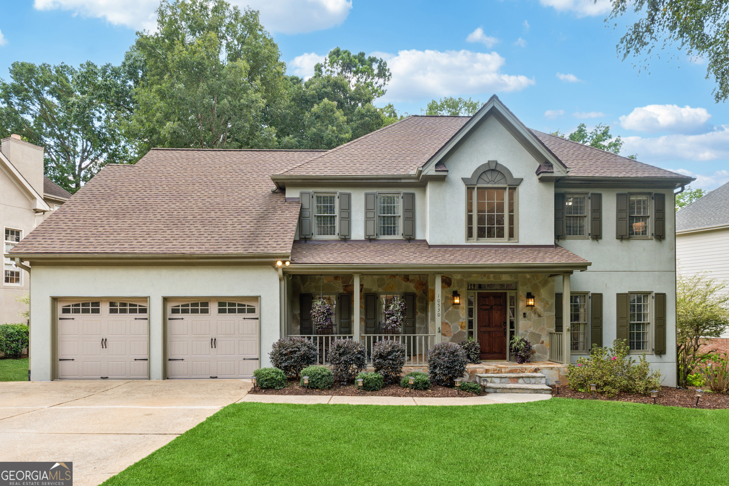 Nestled in the heart of Tuxford-one of Alpharetta's most sought-after swim and tennis communities-10530 Tuxford Drive blends classic charm with modern upgrades and everyday functionality. With 6 beds, 4 full baths, and a fully finished terrace level, this beautifully maintained home provides plenty of space to live, entertain, and grow in a vibrant, family-friendly neighborhood. From the welcoming front porch and flat, manicured lawn to the timeless exterior, this home delivers instant curb appeal. Inside, you're greeted by a soaring 2-story foyer and gleaming hardwood floors that flow throughout the main level. The layout is both elegant and practical, featuring a formal living room, a spacious dining room, and a fireside family room with vaulted ceilings and a stunning floor-to-ceiling brick fireplace. The kitchen is thoughtfully designed for both style and function-offering abundant cabinet space, granite countertops, double ovens, a centrally located gas cooktop, and casual bar seating. The sunlit breakfast room, framed by large windows, is the perfect spot to enjoy your morning coffee while overlooking the peaceful backyard. Upstairs, the oversized primary suite is a true retreat with tray ceilings, a walk-in closet, and a spa-inspired bath ensuite complete with dual vanities, soaking tub, and separate shower. Secondary bedrooms are spacious and bright-ideal for family, guests, or flexible use as home offices or playrooms. The finished basement adds incredible value and versatility, featuring a second fireplace, guest suite, large media or recreation area, and walk-out access to a covered patio and level backyard-perfect for entertaining, playtime, or relaxing in the shade. This home has been meticulously maintained! Tuxford isn't just a neighborhood-it's a community. Residents enjoy a calendar full of social events, a competitive and well-loved swim team, active tennis leagues, and clubs for all ages. Top-rated schools, close proximity to Avalon, North Point, downtown Alpharetta, and easy access to GA-400 make this location unbeatable. Whether you're looking for more space, move-in ready comfort, or a sense of connection and community-10530 Tuxford Drive is ready to welcome you home! UPGRADES INCLUDE: NEWER ROOF (2021); NEWER HOT WATER HEATER (2021); NEWER HVAC UNITS (2018; 2023); NEW DECKING (2025); FRESH INTERIOR PAINT (2025); KITCHEN CABINETS REPAINTED (2024); NEW LIGHTING & HARDWARE THROUGHOUT (2024); and NEW CARPET IN BASEMENT (2025).
