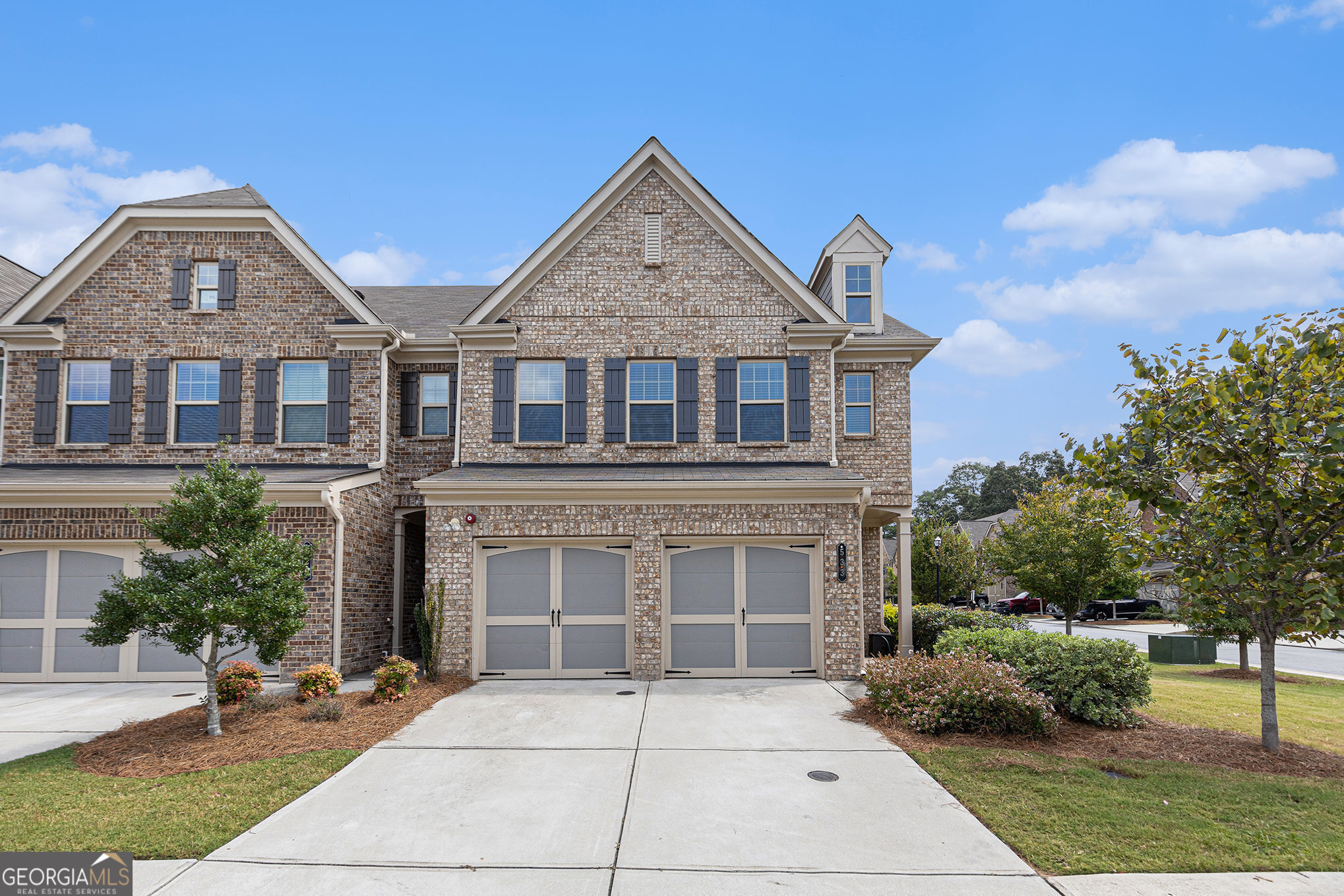 VACANT AND MOVE-IN READY! Welcome to this beautifully maintained end-unit townhome in Promenade at the Square, just minutes from Marietta Square. Built in 2019, this spacious two-story home offers over 2,000 square feet with an open-concept main level featuring a family room with fireplace, dining area, and a modern kitchen with breakfast bar and pantry. Upstairs, the primary suite includes a spa-like bath with double vanity, soaking tub, and separate shower, along with two additional bedrooms and laundry room. Enjoy outdoor living on the front porch and fenced backyard, plus a two-car garage with kitchen-level entry. Community amenities include sidewalks, street lights, and pool in the Marietta City School District.