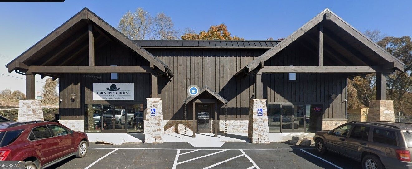 Prime location on the biggest intersection in Blue Ridge, GA! Assumable Seller Financing! New Publix Retail Center planned opening for 2026 on the adjoining parcel! Former Blue Ridge movie theatre converted to a 9,200 sf multi-tenant retail building on 1.2 acres. Completely renovated and updated in 2023 with all new HVAC systems, electrical, plumbing, fixtures, flooring, windows and entry. Beautiful interior design with stone fireplace and heavy timber beams. Excellent opportunity for investment or owner/user with two 3,500 sf retail storefronts on ground level and 2,200 sf office/retail on second level. Sale includes apparel store with fixtures, furniture and inventory in Suite A. Outdoor and firearms store in Suite B operates under new lease. Suite C second floor space is currently vacant and ideally suited for professionals, attorneys, financial service providers or small business. Convenient access from Hwy 515 or Blue Ridge Dr. This intersection is planned for a major redesign by GA DOT in 2025 which will provide improved access to the subject property.