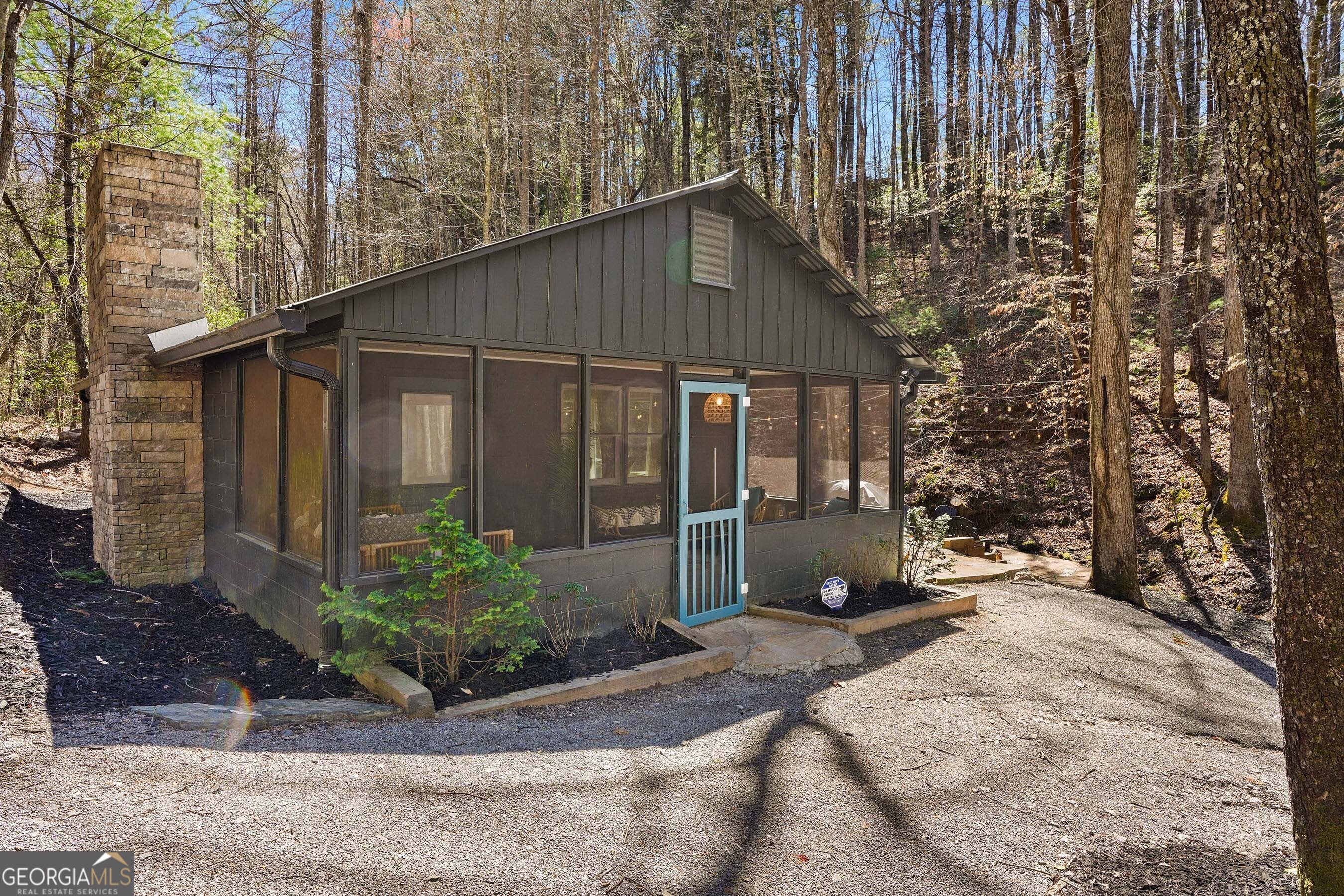 Escape to Blackbird Cottage-an inviting studio tucked in the woods, boarded by a peaceful creek and surrounding forestry land. This fully furnished getaway is a proven short-term rental, blending funky rustic charm with modern comforts. Inside, the open-concept layout features a king-size bed, full kitchen, cozy gas fireplace, and thoughtfully built-in bunk beds that maximize space without sacrificing privacy. The spa-like bathroom includes a floor-to-ceiling tile shower and a tankless water heater so you never have to cut a shower short. Step outside and unwind on the screened in porch an ideal spot for morning coffee or quiet reading. Out back enjoy a dip in the hot tub, or gather around the creekside fire pit for weenie roasting and s'more indulgence. A BBQ grill and outdoor seating make it easy to entertain or simply take in the quiet surroundings. Just a short drive to the shores of Lake Blue Ridge and the Toccoa River, this property offers the perfect mix of seclusion and adventure. Whether you're looking for a weekend retreat or a turnkey rental investment, Blackbird Cottage delivers.
