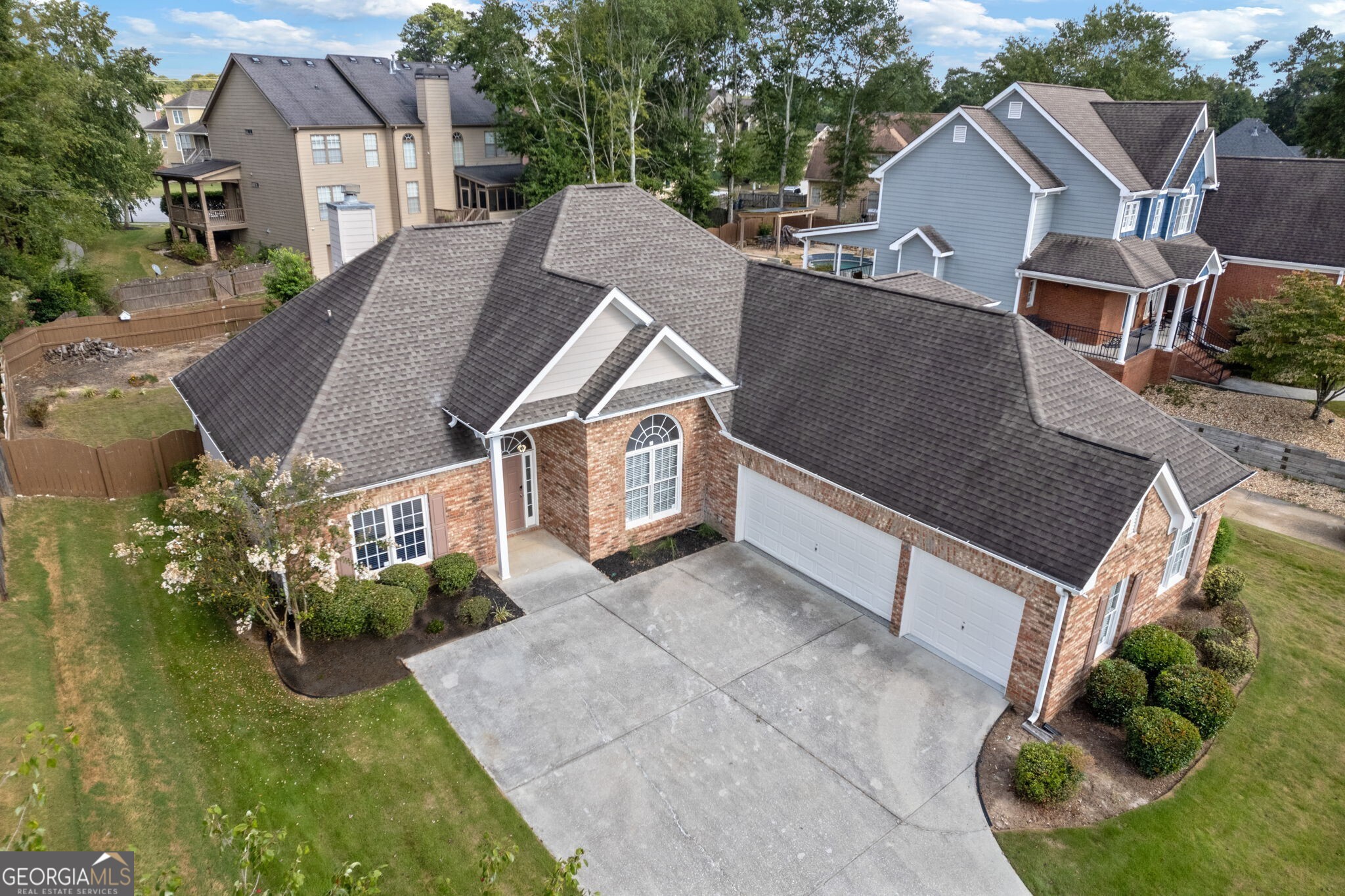 Located in the Grayson High School District, this modern 4-bedroom, 3.5-bathroom home in Loganville is beautiful, both inside and out. The Essentials: There is a large living room with a contemporary marble gas fireplace and unique contemporary lighting throughout. There is a separate dining room and an eat-in kitchen featuring granite countertops and stainless steel appliances. The kitchen also includes a chef-quality gas stove. The master bedroom on the main level has an attached bathroom with double sinks and a walk-in shower. There is also an expansive closet. Two additional spacious bedrooms are on the main level as well. They share a full Jack and Jill bathroom with double sinks. This home also features a fourth oversized bedroom upstairs with a full bathroom. The large sunroom off the living area opens to a huge covered patio, complete with a gas line for grilling. The Exceptional: 3-car garage with a partition wall to keep equipment out of sight. Tankless water heater system installed in 2023. New roof installed in 2019. Gas line to the laundry room for gas appliances; gas washer included. There is spacious attic storage space that is easily accessible and perfect for all your storage needs. This home offers a wired alarm system and a security camera system with a DVR included. Heat and drought-tolerant Zoysia grass covers the lawn.