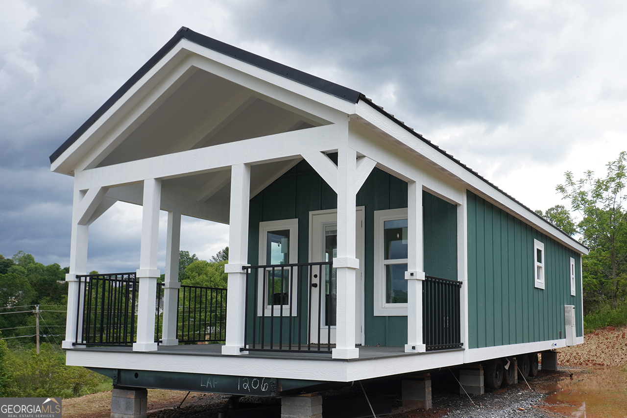 Welcome to Lot #2 in Peaceful Meadows, a growing Tiny Life Village just outside of Franklin, NC. This newly built 2024 Madison model is a beautifully designed 396 sq ft (14' x 40') RV park model tiny home featuring 2 bedrooms and 1 full bath. Thoughtfully laid out, it comfortably sleeps up to 4 people and sits on a spacious 0.43-acre lot. Peaceful Meadows spans 28 acres and will feature 78 homes at completion. Residents enjoy a peaceful, community-oriented lifestyle with modern amenities including paved roads, water, septic, high-speed internet, and professionally maintained landscaping in shared green spaces. Future amenities under development include: * Gated entrances * Clubhouse with fitness room & pavilion * Picnic area * Pickleball court * Dog park Please note: Home is not available for occupancy until utilities are installed and final setup is complete-estimated move-in ready by early July 2025. Active construction site - use caution when visiting.