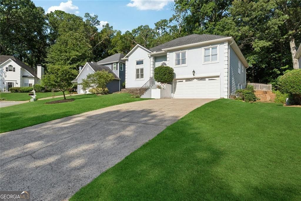 REFRESHED FOR THE MARKET! This beautiful home comes with a 4.2% interest rate with qualifying lender! Save over $600+ on your monthly mortgage payment! Welcome to 760 Whitehall Way in the desirable Whitehall neighborhood of Roswell. This spacious home sits on a quiet, private lot and offers a great mix of space, comfort, and versatility. Inside, you'll find vaulted ceilings and large windows that bring in tons of natural light. The main level features hardwood and tile floors, an updated kitchen with plenty of storage, and a cozy fireplace in the living area. All bathrooms have been recently renovated with clean, modern finishes. Not to mention this beautiful home has a brand new AC unit, new roof, new gutters, and new paint inside. The finished terrace level includes its own private entrance, a second updated kitchen, another living space with a fireplace, a bedroom, and a full bath-ideal for extended guests, in-laws, or work-from-home needs. The fenced backyard features a spacious deck and offers just the right amount of privacy. Located just minutes from both Downtown Roswell and Alpharetta, you'll have easy access to parks, shopping, restaurants, top schools, and major commuter routes. It's a well-maintained home in a sought-after Roswell location with room to make it your own!