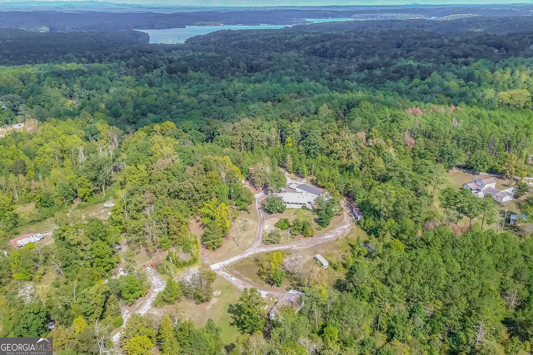 Don't miss this incredible opportunity! 13.88 acres available for residential development, featuring an easement to New Hope Road, ideal for adding a road or bringing in sewer. The lot is partially cleared with county water and a private road already in place, six septic tanks already installed on site and ready to go. Two mobile homes on the lot that can be removed, and a 3 bedroom home with a massive porch and shop can be found at the backside of the property. Located just steps from Lake Allatoona, Glade Marina, Red Top Mountain State Park, and more! Easy access to shopping, dining, and entertainment, just 5 minutes to I-75. Very close to Hwy 92, and Hwy 41. Sellers are willing to cooperate with planning and development of the easement. This is a prime development opportunity. Bring your offers and vision!