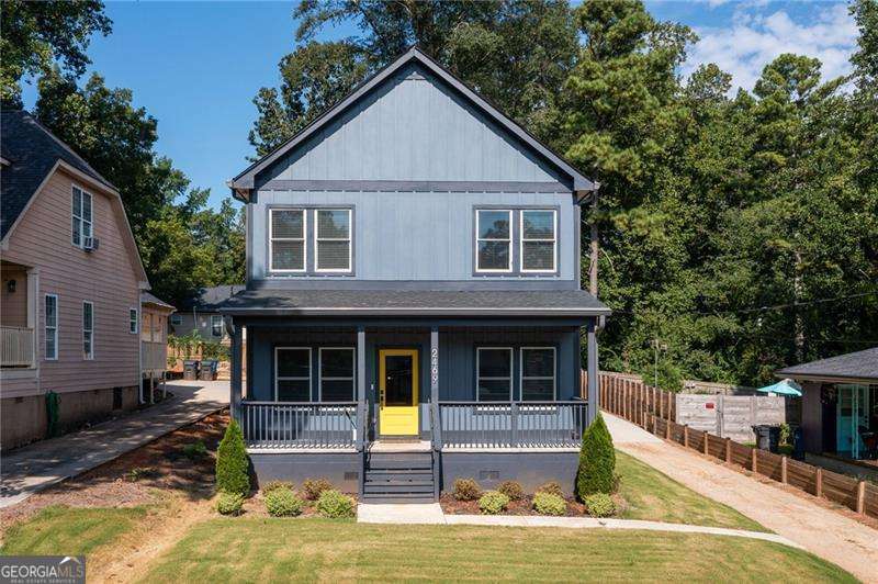 Modern style and everyday comfort come together in this newer construction gem in Jefferson Park, tucked away on a quiet street with eye-catching curb appeal. Fresh exterior paint and a sunny yellow front door set the tone before you even step inside. A covered front porch welcomes you into a bright entry with a cozy flex space ready for kicking off shoes, dropping bags, or curling up with a good book. The open-concept layout makes both hosting and daily living feel effortless, with seamless flow between the living, dining, and kitchen spaces. The chef's kitchen is the real showstopper. Navy cabinetry, quartz counters, gold accents, soft-close drawers, and a big island that begs for brunch with friends. Stainless appliances tie it all together with a polished finish. Downstairs also delivers a full guest suite with a private bath, double vanities, granite counters, and a tiled walk-in shower; perfect for long-term visitors or your next work-from-home setup. Upstairs, the oversized primary suite is your retreat at the end of the day with two walk-in closets and a spa-style bath complete with soaking tub, custom tilework, double vanities, and a separate shower. Two more bedrooms share a sleek full bath with double vanity, and the laundry room is right where you want it, upstairs and spacious. Out back, the covered patio and fenced yard are ready for grilling, gardening, or weekend hangs. A detached two-car garage sits at the rear with plenty of storage and parking. This one checks all the boxes with style, space, and a location that keeps you close to everything. You're just minutes from Brookdale Park, Woodward Academy, and Hartsfield Jackson, with all the food, shopping, and local flavor of East Point, College Park, and Hapeville right around the corner.