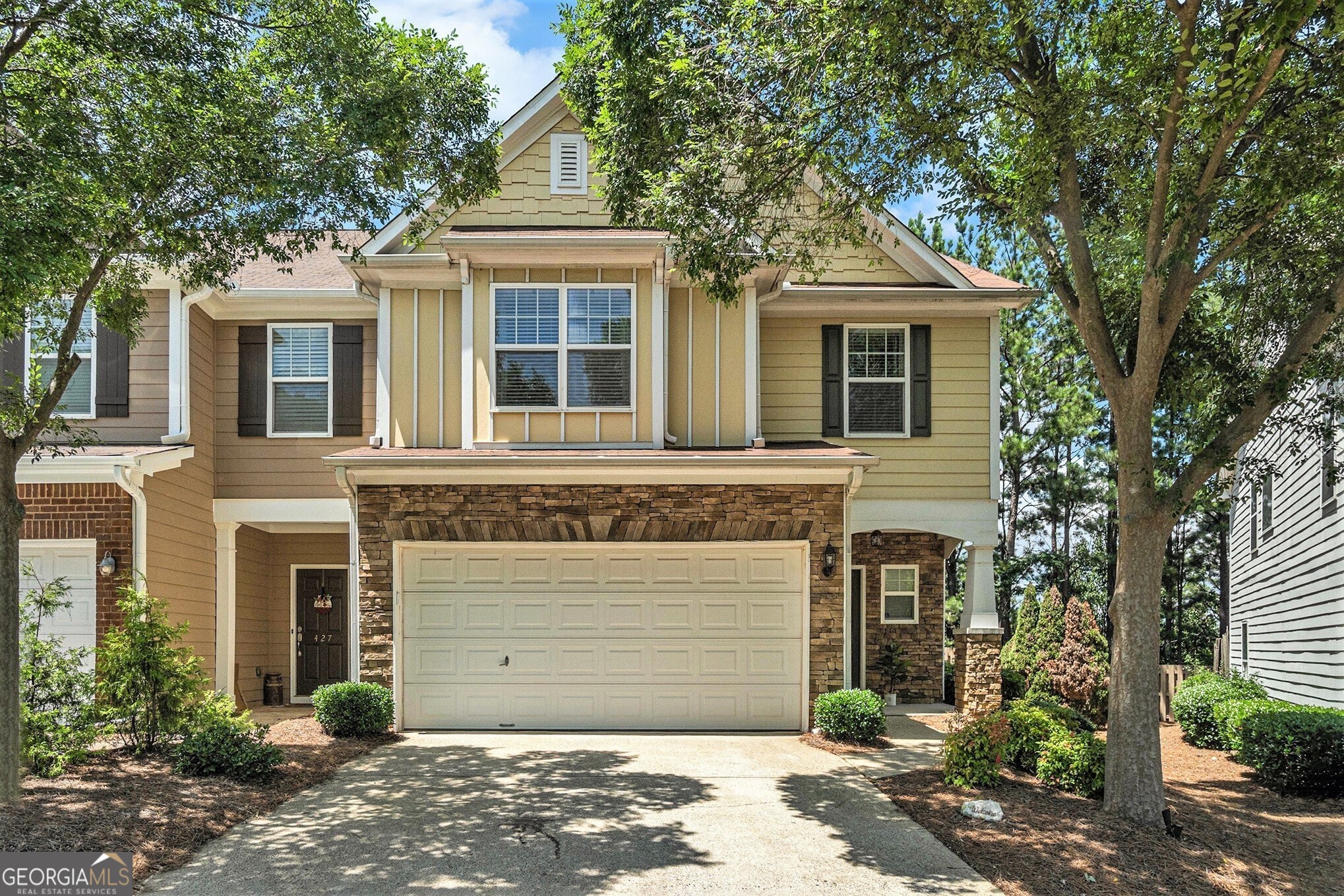 Welcome Home to this Light and Bright 3 Bedroom, 2.5 Bath End Unit Townhome in the Sought-After Mountain Brook Community Complete with Swim, Trails, and a Private Lake! The Open Concept Main Level Floorplan features a Two-Story Living Room with a Cozy Gas Fireplace, a Spacious Dining Area with Crown Molding and Wainscoting, and a Generous Kitchen with Stainless Steel Appliances, a Breakfast Bar, Wooden Shaker Cabinets, and a Walk In Pantry. A Convenient Half Bath on the Main adds function and flexibility. Upstairs, the Oversized Owner's Suite includes Trey Ceilings, a Luxurious Bath with a Soaking Tub, Separate Shower, Double Vanity Sinks, and an Expansive Walk-In Closet. Two Additional Bedrooms and a Full Bathroom offer plenty of space for family or guests. Fresh Interior Paint and Brand New Carpet make this one Truly Move-In Ready! Step outside to your Walk-Out Patio and Grassy Area Perfect for Grilling Out, Pets or a Private Garden. Enjoy Top-Tier Amenities like a Swimming Pool, Fishing Dock, Playground, and Miles of Walking & Hiking Trails. Tucked away in a Quiet Spot just off HWY 92 with Easy Access to 575 & 400, and just minutes from Downtown Roswell, Downtown Woodstock, Marietta, Shopping, Restaurants, and Entertainment This is the One You've Been Waiting For!