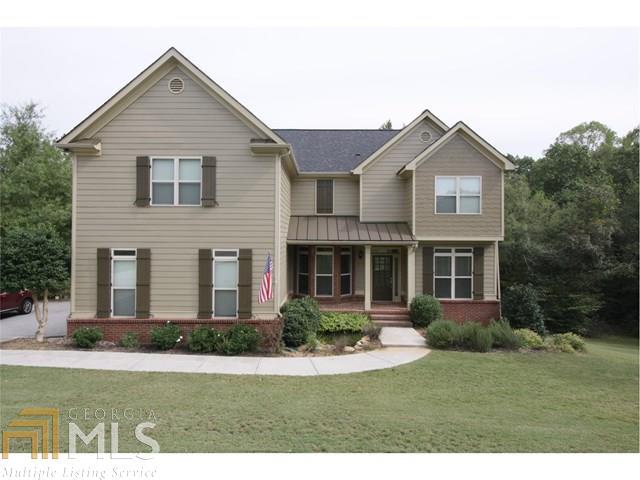 This is the home you've been waiting for complete with inground pool and 4 car garage! Island kitchen with granite, s/s appliances, hardwood floor, & view to the family room. Bedroom & full bath on main. King size master suite, oversized shower with double vanities in Master bath & large walk-in closet. Terrace level has a wet bar, theater room that seats 8, and full bath. Great for entertaining. Private wooded backyard with pool, covered patio, and deck. Must see this beauty to appreciate!