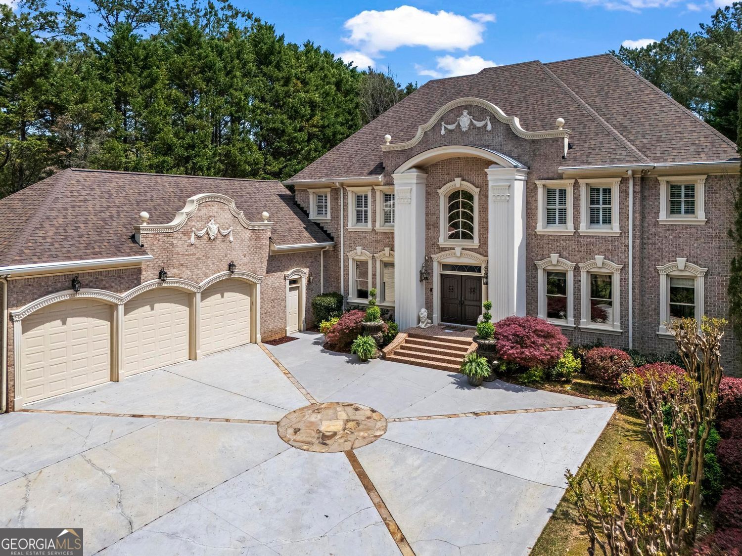 Spectacular brick custom built estate located on the Golf Club Of Georgia "Lakeside", In Gated Northshore of Windward. The grand entry will "take your breath away!" with a curved staircase and stunning shimmering chandelier. Enchanting living areas radiates elegance and thoughtful craftmanship throughout this custom-built home with hardwood flooring and extensive crown molding. Step right out from the main living area to your own private resort with swimming pool, spa & waterfall surrounded by a stone patio and private lawn plus access to a full bathroom. The two -story formal living, banquet size dining rooms and paneled study boasts beautiful chandeliers. The charming family room features a stone two- sided fireplace and opens to a chef's granite gourmet kitchen-one of three full kitchens, including a second prep kitchen nearby and a full kitchen on the terrace level, ideal for entertaining on every scale. Separate eating area leads to a cozy sun room overlooking the fabulous outdoor stone patio and beautiful swimming pool. The owners retreat on the main level enjoys a custom fireplace, built-in cabinetry and has views of the waterfall pool and private back yard. Luxurious bathroom with double vanities, water closet with bidet and walk in closet plus private access to the paneled study. Four spacious additional bedrooms on the second level enjoy private baths and custom walk in closets and separate back staircase. An entertainer's dream and/or second home on the terrace level with a full double island granite kitchen, home theater, mirrored exercise room, steam shower, sauna, guest suite with private bath and travertine flooring. This home delivers unparalleled luxury and lifestyle in one of Alpharetta's most desirable gated communities. The Northshore of Windward has it's own clubhouse, sport court, swimming pool and tennis courts. Windward is a 3,400 acre master planned community that enjoys an award winning environment that has been designed to take full advantage of the private 195 acre Lake Windward. A private membership at Windward Lake Club, with tennis center, pools and marina available. Enjoy fishing, canoeing and sailing on this peaceful setting. This community surrounds The Golf Club of Georgia, a private membership club with two 18-hole championship courses. Extra Details: two laundry rooms, three kitchens, irrigation system and wired for the future.